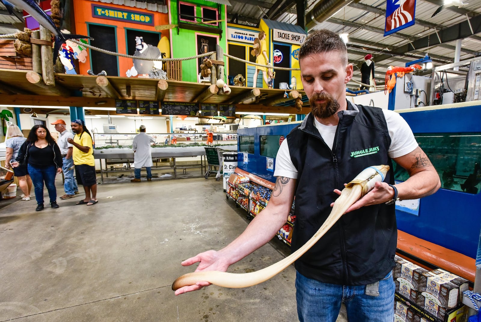 Ross Carroll, seafood buyer and manager for Jungle Jim’s International Market, holds a geoduck in the seafood department Thursday, Sept. 26, 2019 at the store’s Fairfield location. Carroll recently brought in fresh alligator to both Fairfield and Eastgate locations. The seafood department has a variety of freshwater, saltwater and exotic species. NICK GRAHAM/STAFF