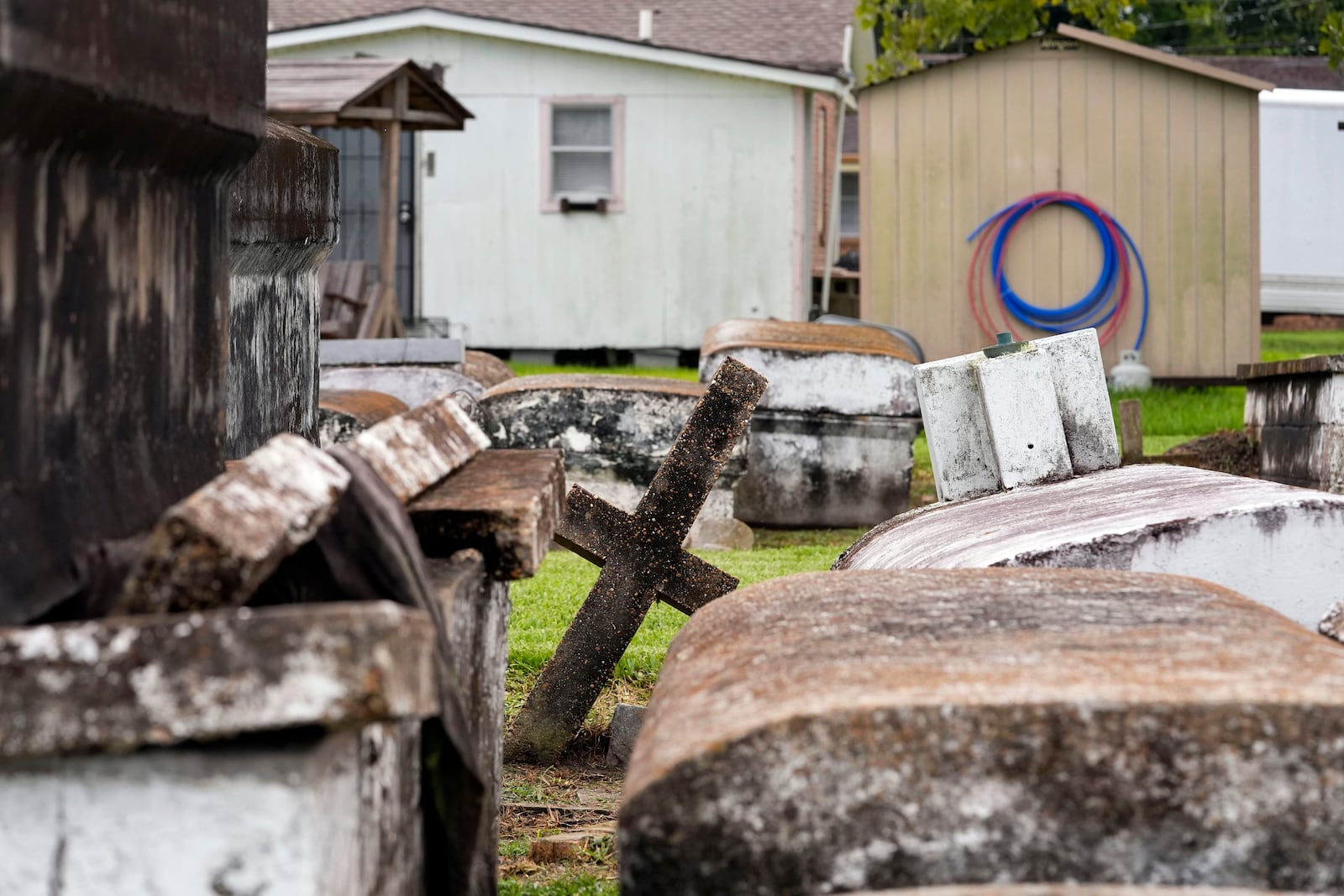 The local cemetery sits near homes in the Elkinsville section of St. Rose, La., Friday, Aug. 16, 2024. (AP Photo/Gerald Herbert)