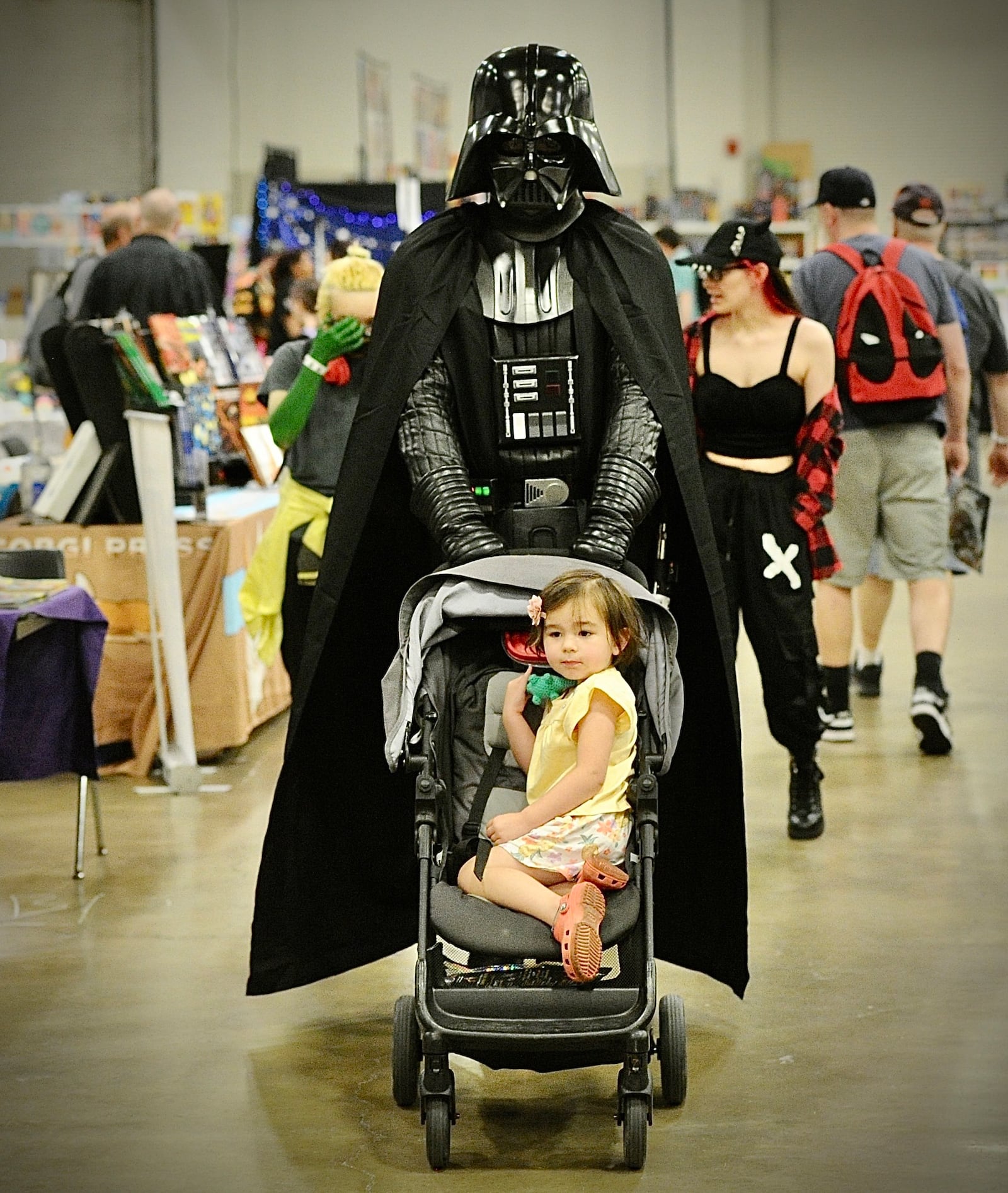 A Gem City Comic Con attendee dressed as Darth Vadar pushes a baby buggy aroung the show Saturday, July 22, 2023. MARSHALL GORBY\STAFF