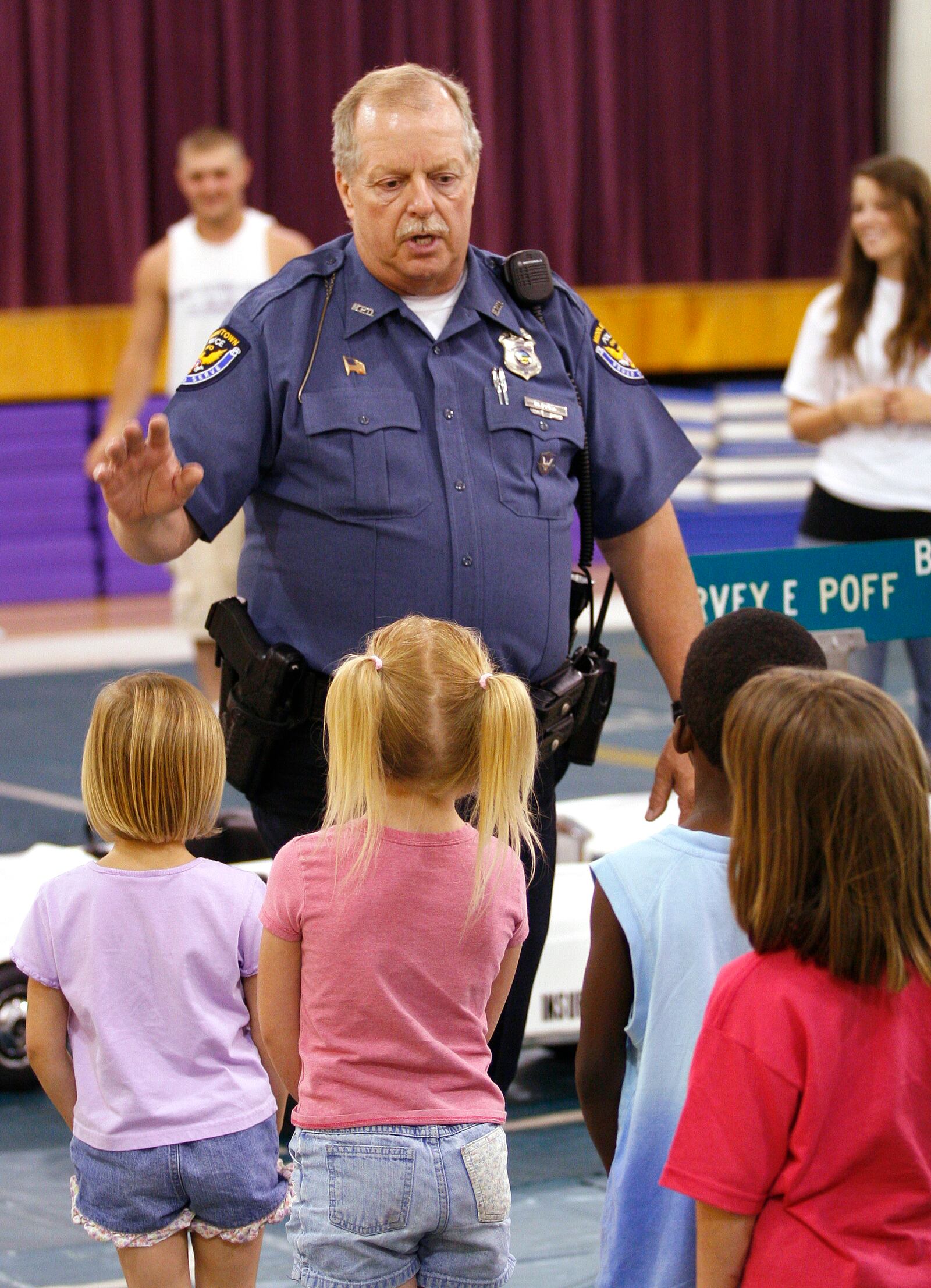 Middletown school resource officer Mike Davis is shown placing youngsters into groups during the first day of Patrolman Jack Combs Memorial Safety Town at Amanda Elementary School in Middletown. Davis, 61, recently was named Middletown police's Officer of the Year.