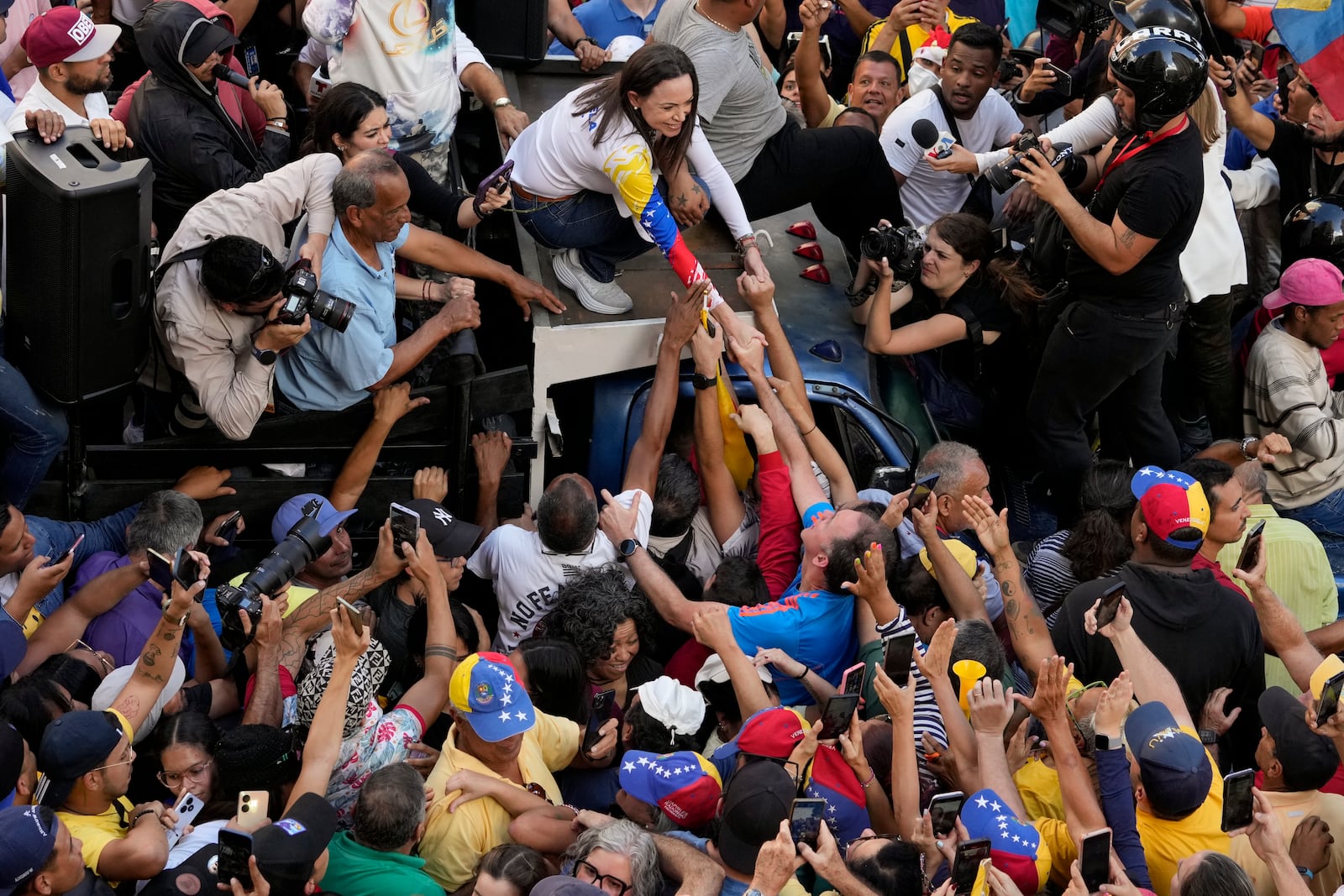 Venezuelan opposition leader Maria Corina Machado greets supporters during a protest against President Nicolas Maduro the day before his inauguration for a third term, in Caracas, Venezuela, Thursday, Jan. 9, 2025. (AP Photo/Ariana Cubillos)