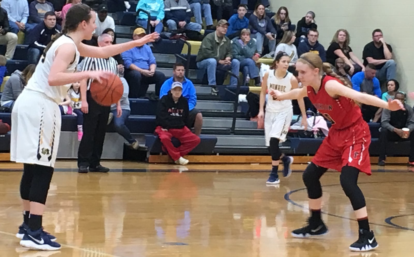 Monroe’s Sophie Sloneker prepares to run a play as Franklin’s Jordan Rogers defends on Saturday night at Monroe. RICK CASSANO/STAFF