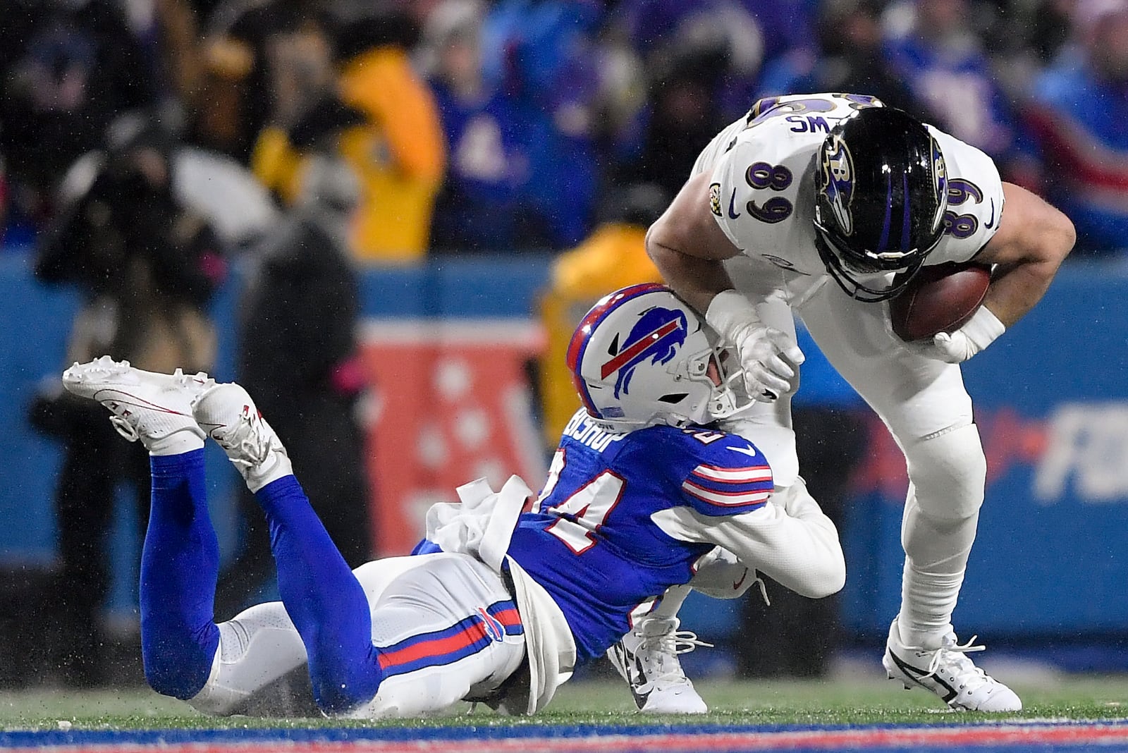 Buffalo Bills safety Cole Bishop (24) tackles Baltimore Ravens tight end Mark Andrews (89) during the third quarter of an NFL divisional playoff football game, Sunday, Jan. 19, 2025, in Orchard Park, N.Y. (AP Photo/Adrian Kraus)