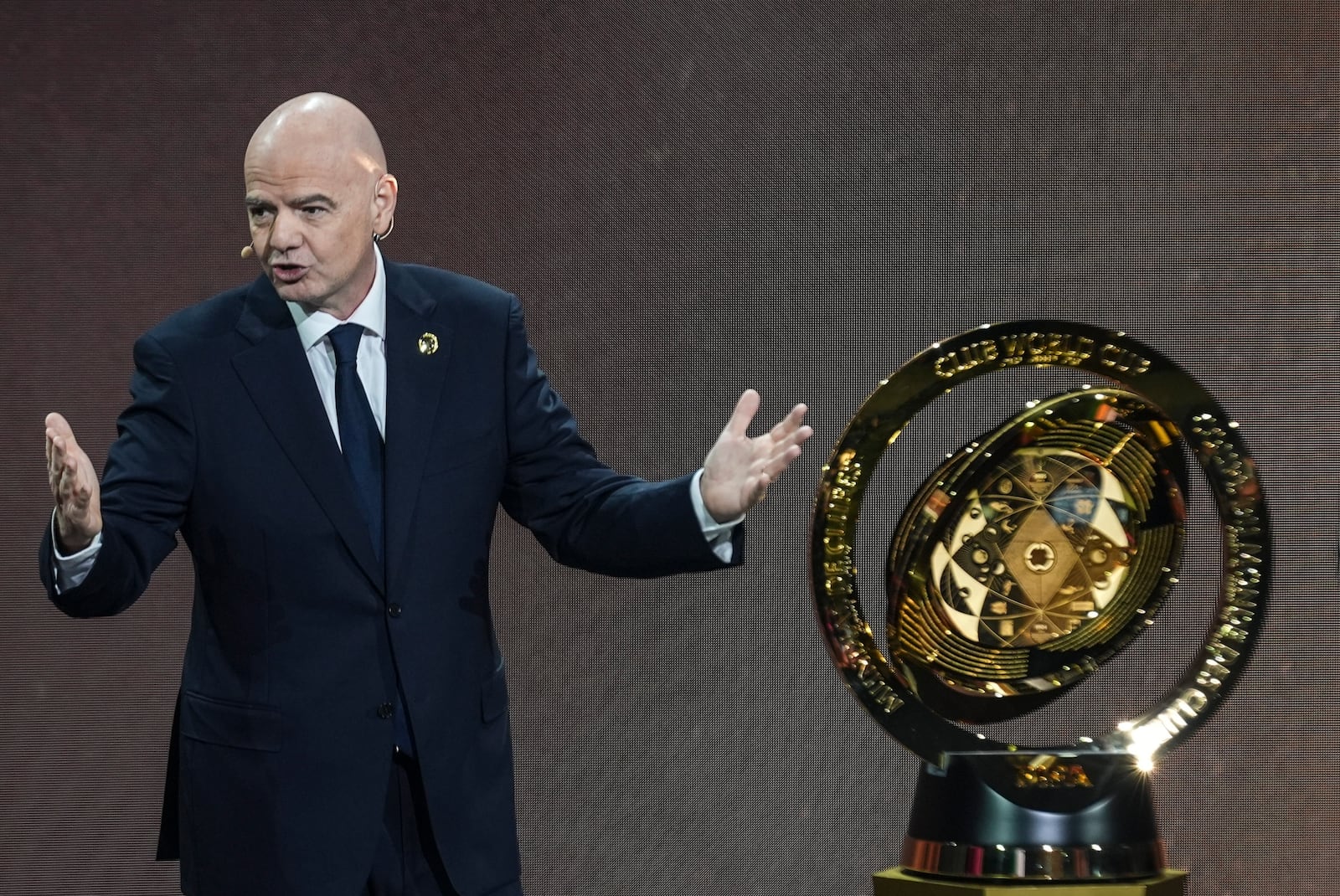 FILE - FIFA President Gianni Infantino' speaks next to the trophy during the draw for the 2025 FIFA Club World Cup soccer tournament, Thursday, Dec. 5, 2024, in Miami. (AP Photo/Rebecca Blackwell, File)