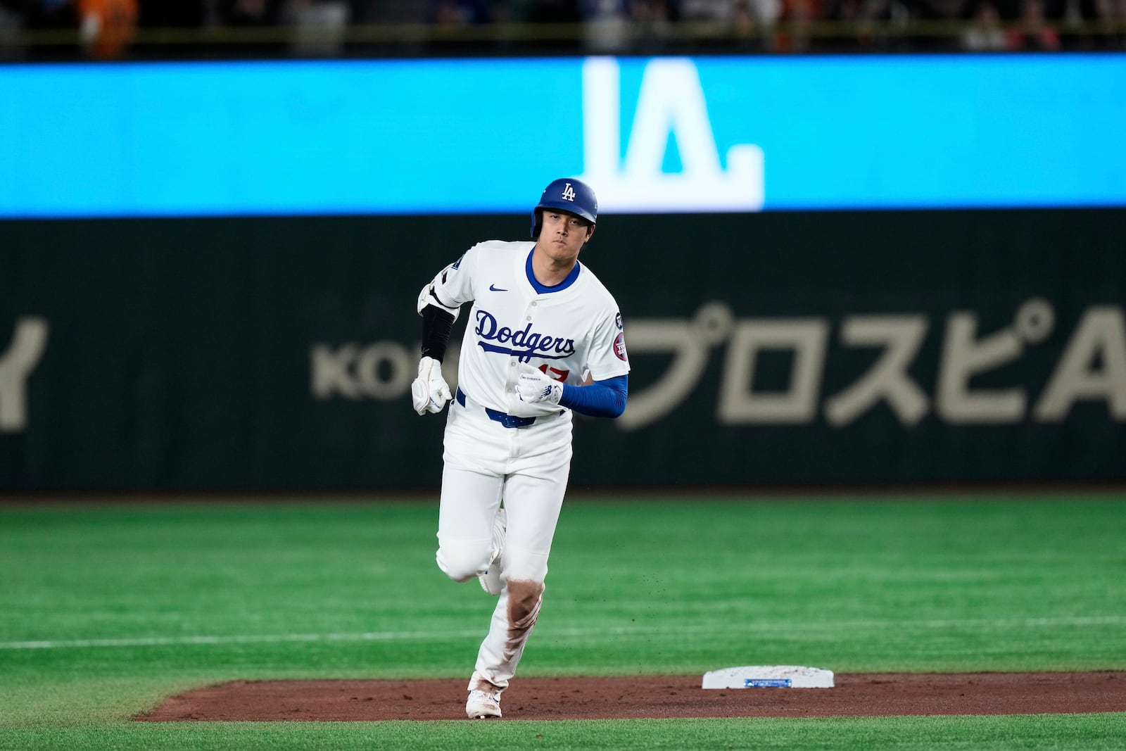 Los Angeles Dodgers' Shohei Ohtani rounds the bases after hitting a two-run home run in the third inning of a spring training baseball game against the Yomiuri Giants in Tokyo, Japan, Saturday, March 15, 2025. (AP Photo/Eugene Hoshiko)