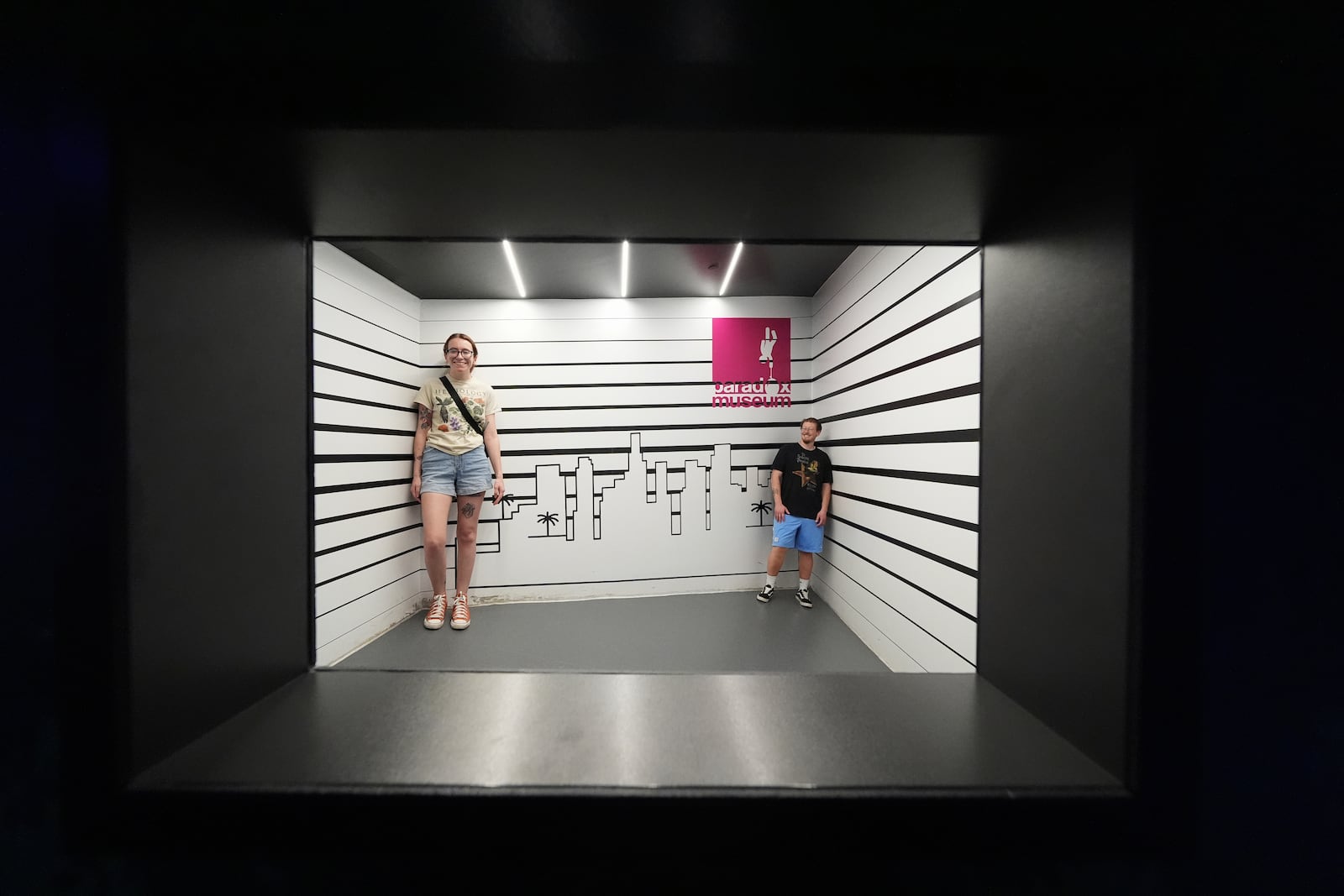 Visitors pose inside a proportion-distorting room at Paradox Museum Miami, Tuesday, Jan. 28, 2025, in Miami. (AP Photo/Rebecca Blackwell)