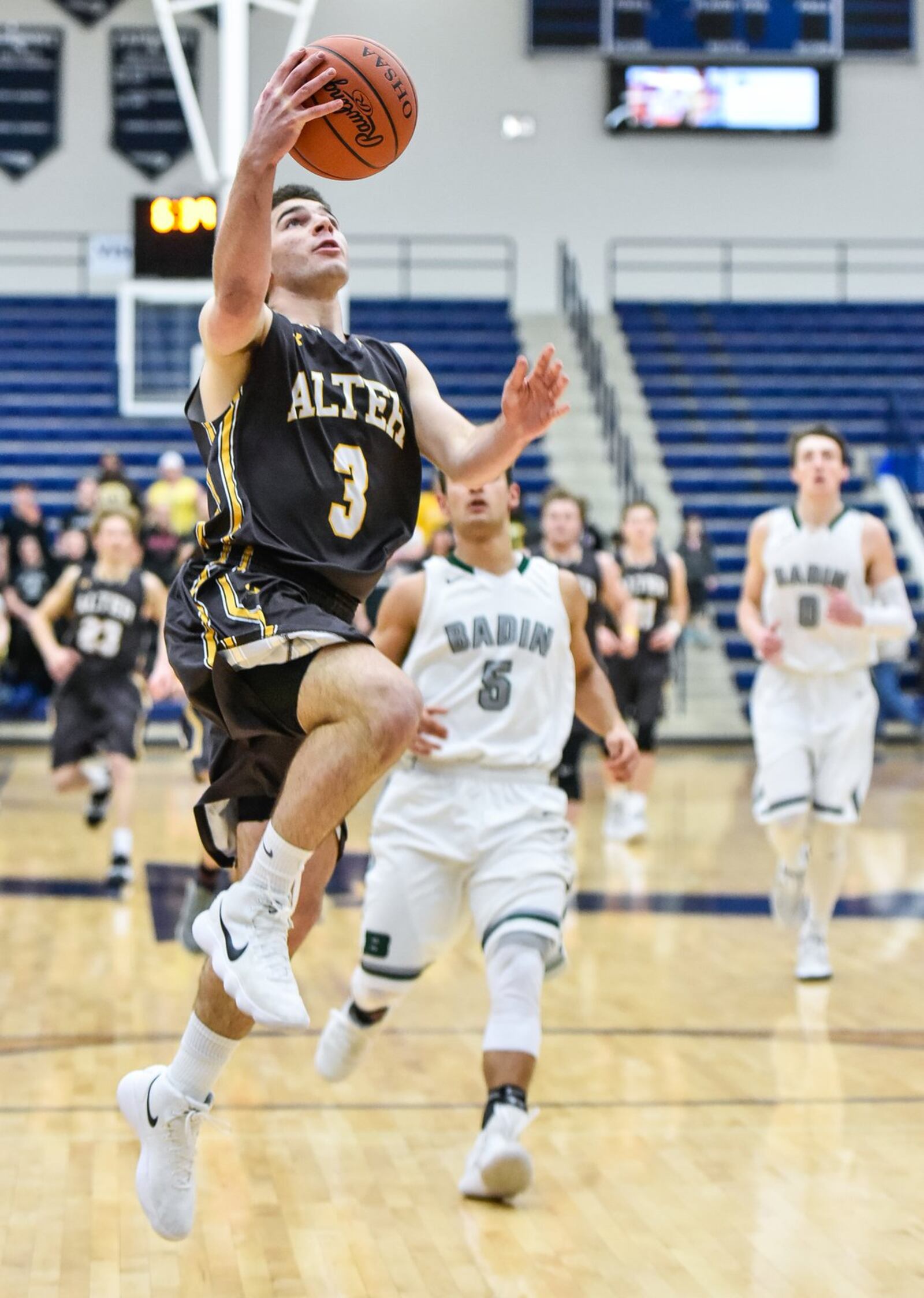 Alter’s Dominic Ruffolo gets past Badin’s Daunte DeCello (5) and heads for the basket during Tuesday night’s Division II sectional semifinal at Fairmont’s Trent Arena. NICK GRAHAM/STAFF