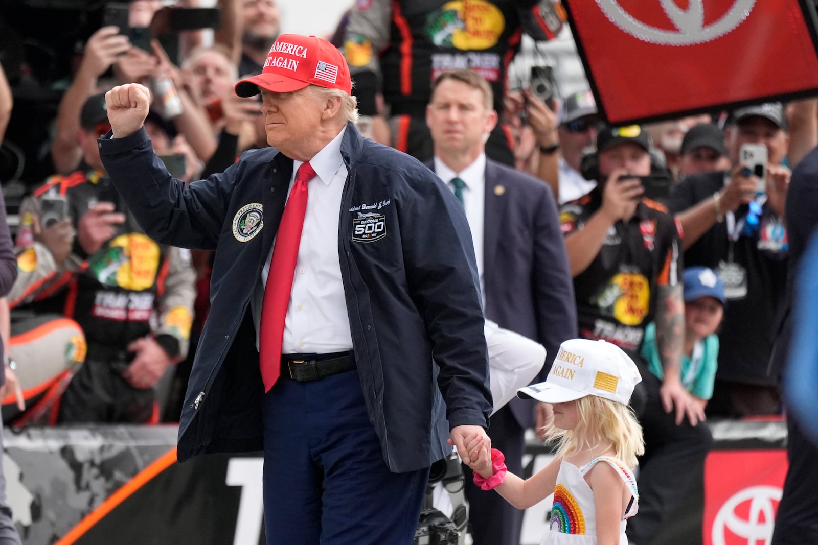 President Donald Trump, with his graddaughter Carolina, attends the NASCAR Daytona 500 auto race at Daytona International Speedway, Sunday, Feb. 16, 2025, in Daytona Beach, Fla. (AP Photo/John Raoux)