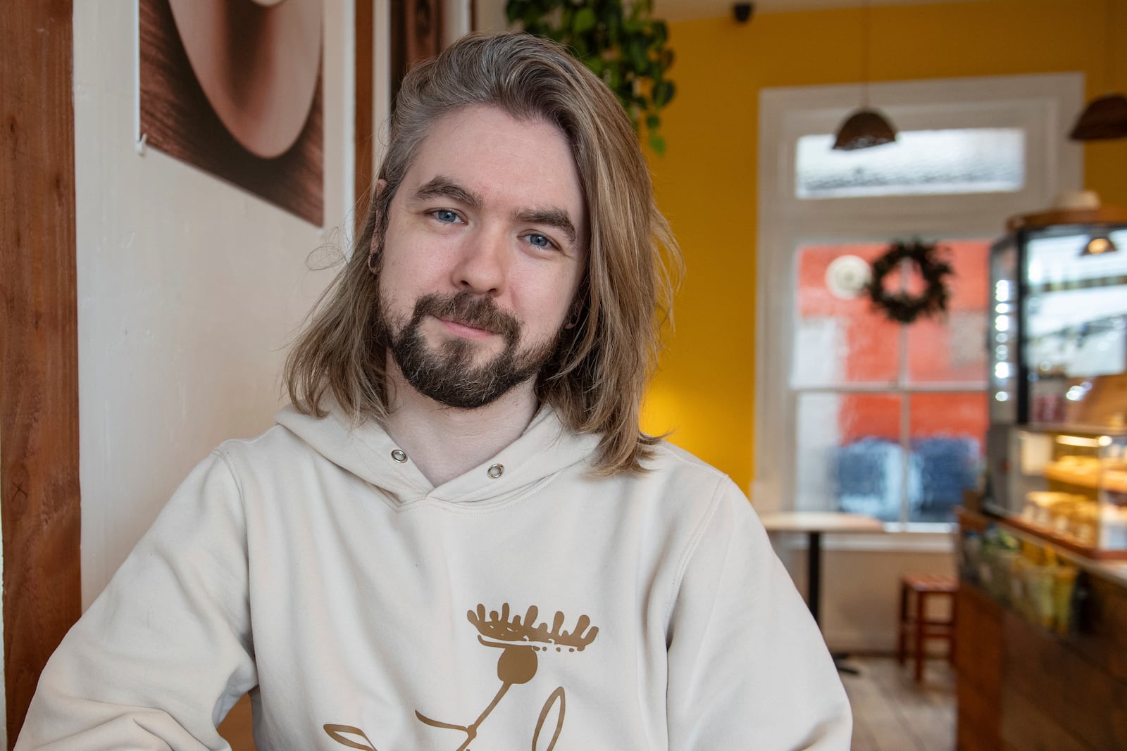 YouTuber Sean McLoughlin, better known as 'Jacksepticeye,' sits at his favorite coffee shop in Brighton, Thursday, November 21, 2024. (AP Photo/Thomas Krych)