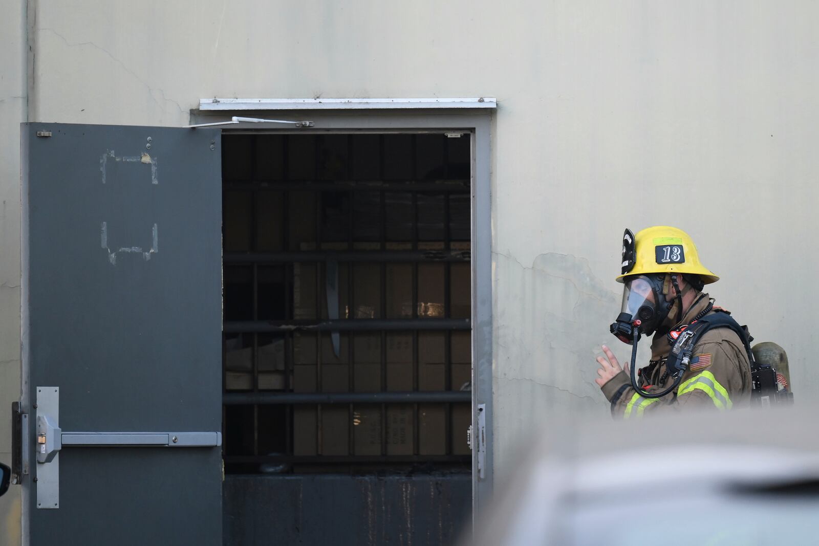 A firefighter enters a building where a plane crash occurred Thursday, Jan. 2, 2025, in Fullerton, Calif. (AP Photo/Kyusung Gong)