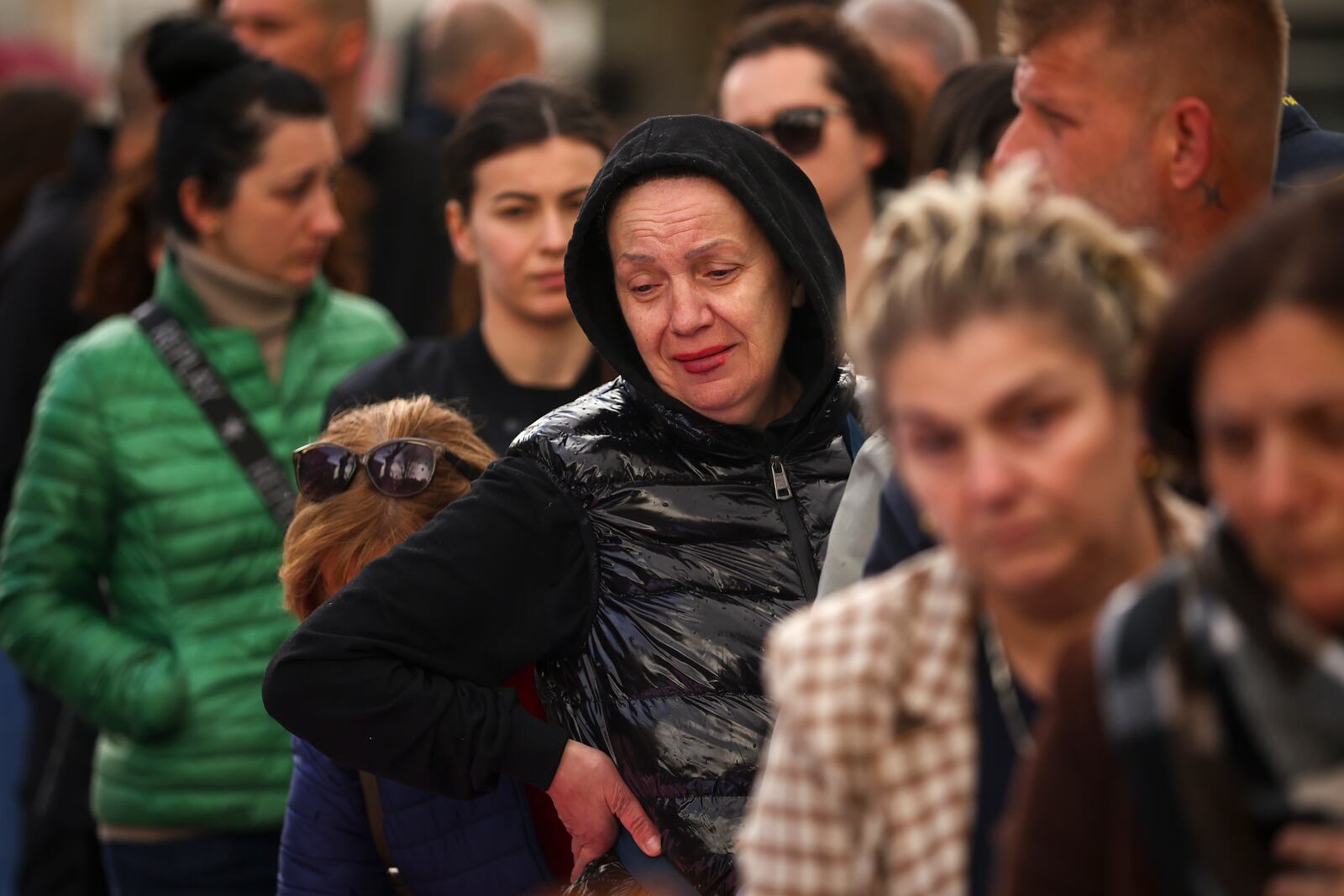 People attend a vigil, joined by hundreds, for the victims of a massive nightclub fire, in the town of Kocani, North Macedonia, Monday, March 17, 2025. (AP Photo/Armin Durgut)