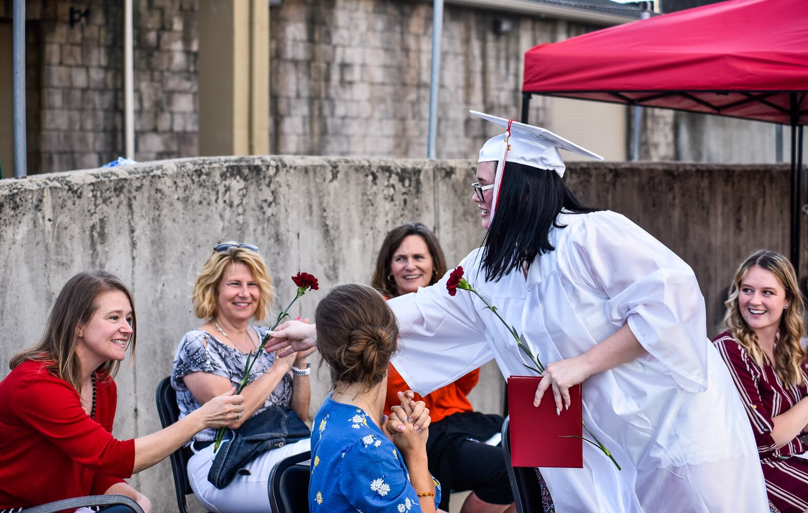 Madison High School drive-thru graduation ceremony at Land of Illusion