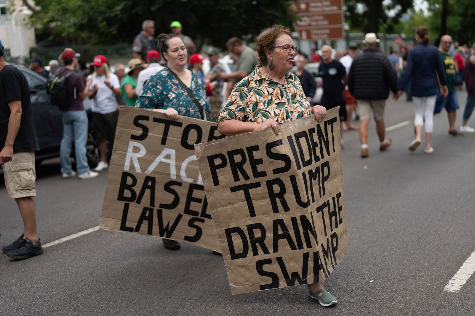 White South Africans demonstrate in support of U.S. President Donald Trump in front of the U.S. embassy in Pretoria, South Africa, Saturday, Feb. 15, 2025. (AP Photo/Jerome Delay)