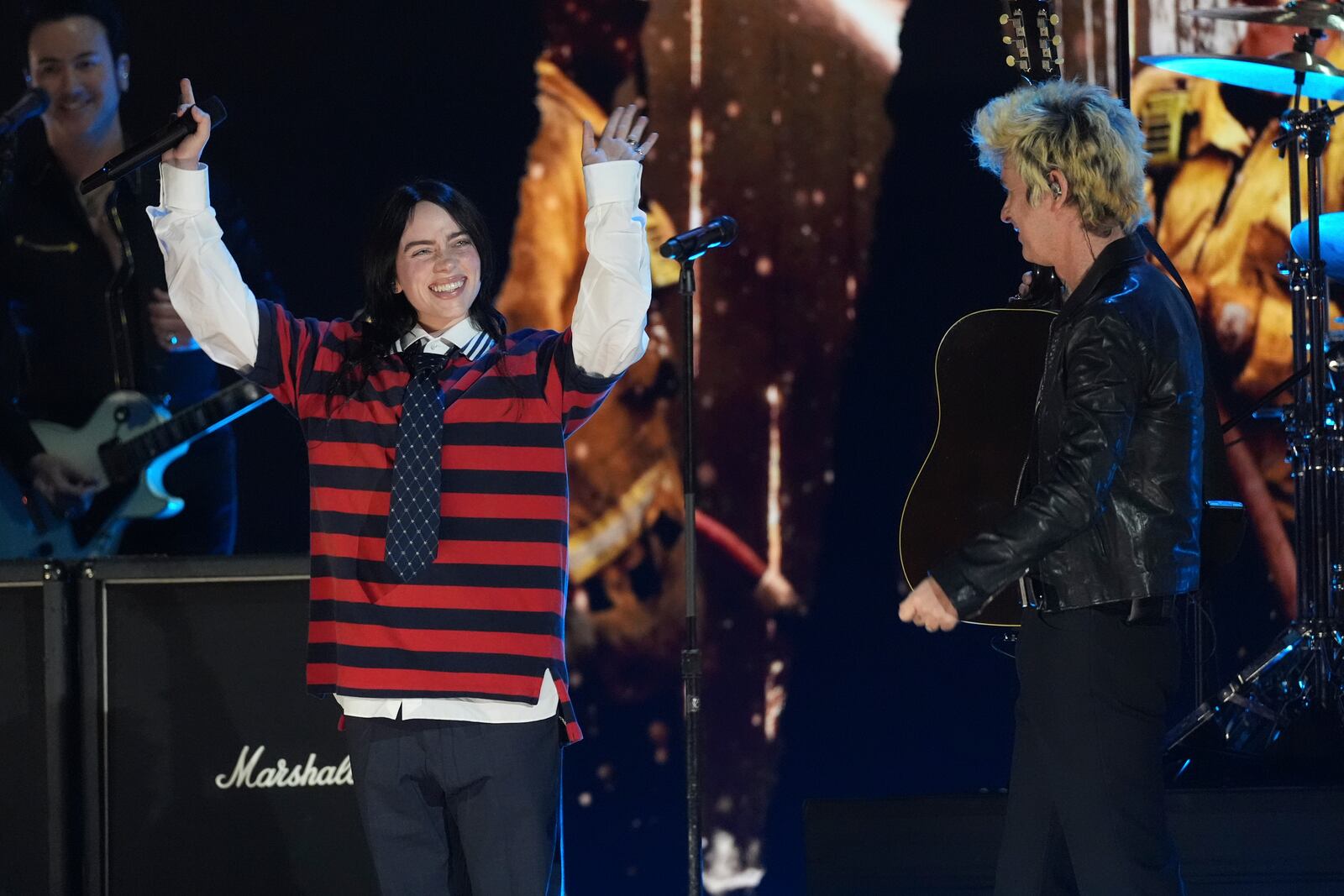 Billie Eilish, left, performs with Billie Joe Armstrong of Green Day during the FireAid benefit concert on Thursday, Jan. 30, 2025, at The Forum in Inglewood, Calif. (AP Photo/Chris Pizzello)