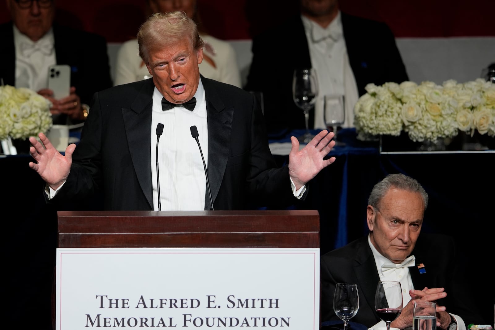 Republican presidential nominee former President Donald Trump speaks as Senate Majority Leader Chuck Schumer of N.Y., listens at the 79th annual Alfred E. Smith Memorial Foundation Dinner, Thursday, Oct. 17, 2024, in New York. (AP Photo/Julia Demaree Nikhinson)