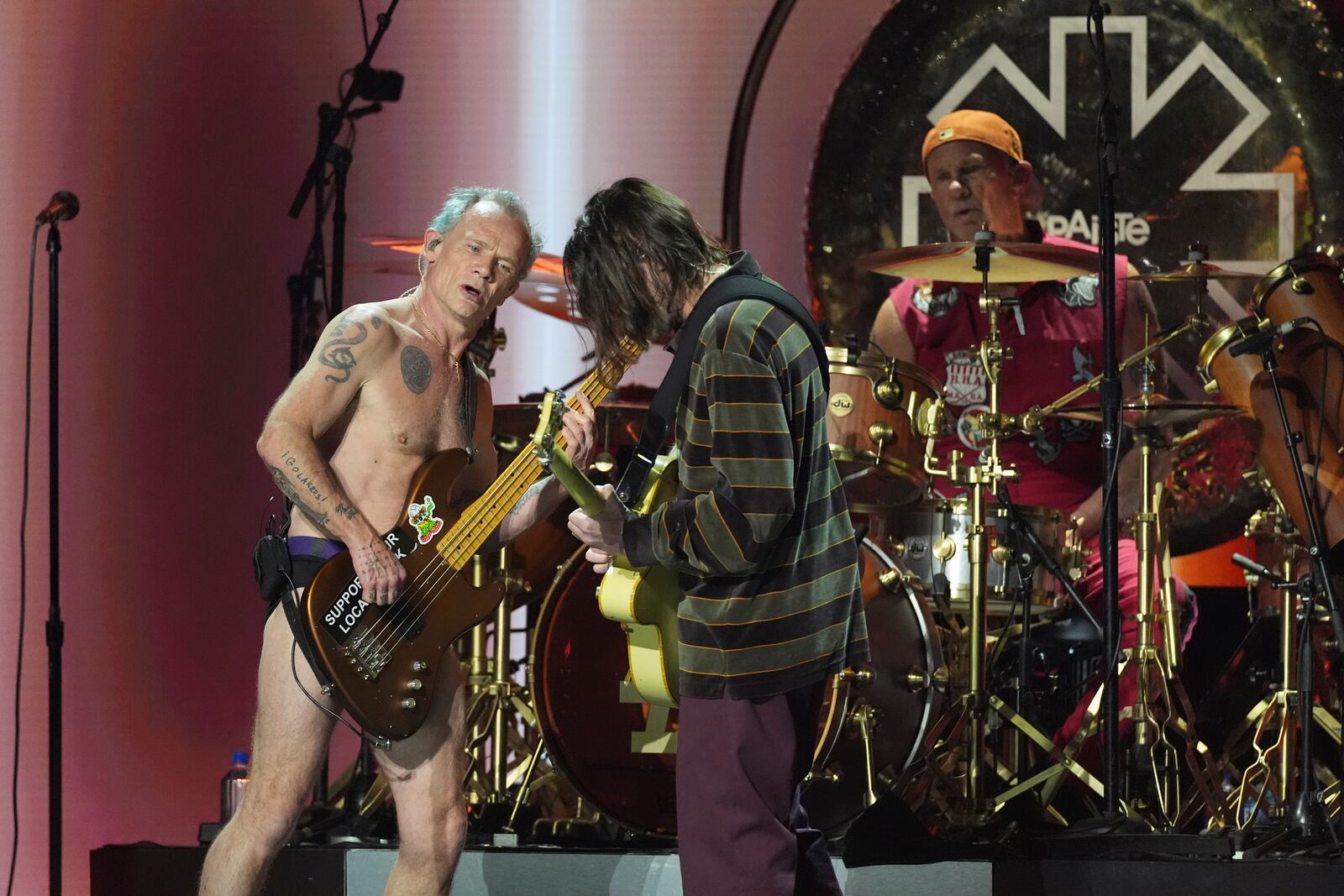 Flea, from left, John Frusciante, and Chad Smith of Red Hot Chili Peppers perform during the FireAid benefit concert on Thursday, Jan. 30, 2025, at The Forum in Inglewood, Calif. (AP Photo/Chris Pizzello)