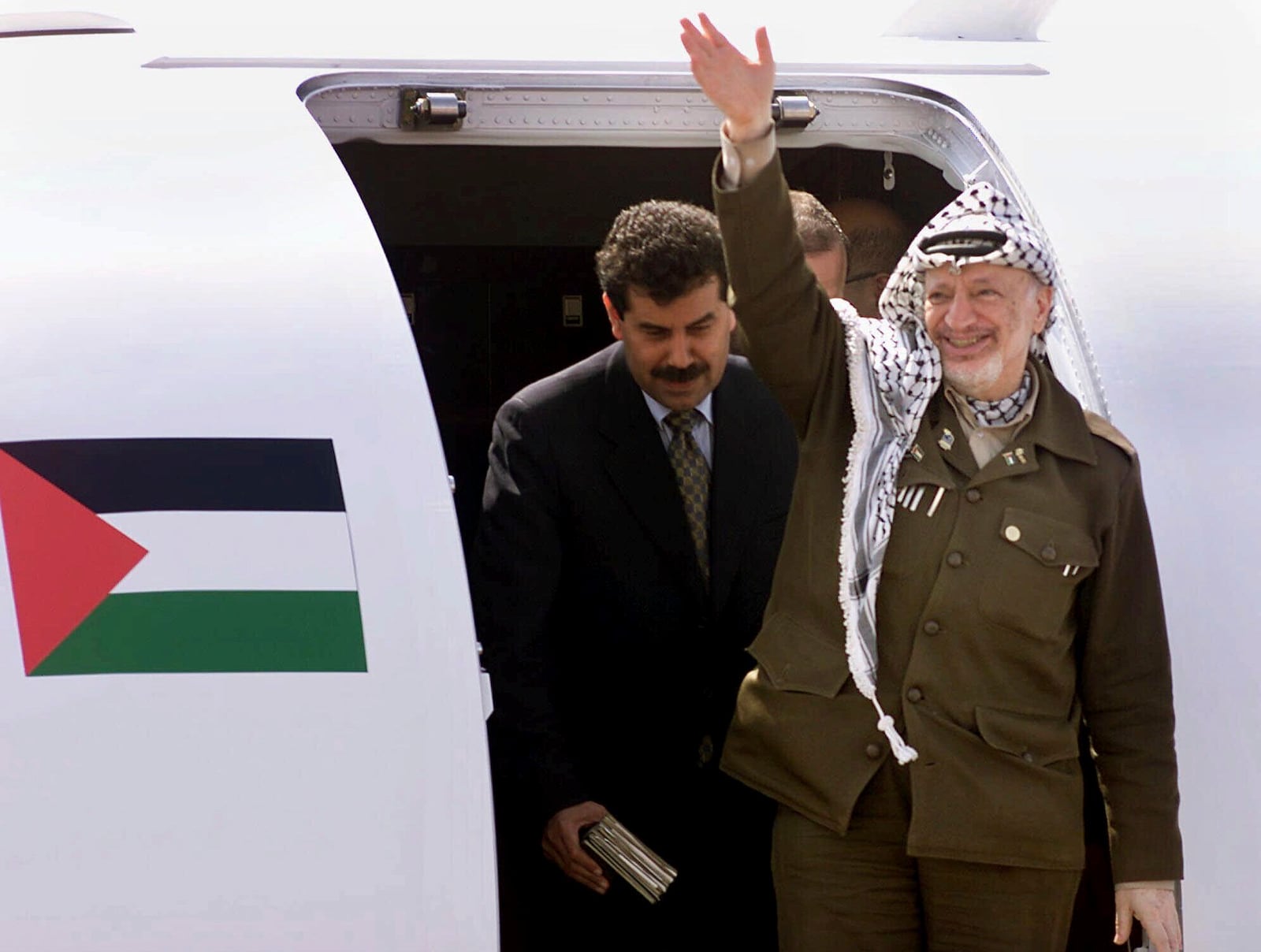 FILE - Palestinian leader Yasser Arafat waves to supporters shortly after his arrival at Gaza International Airport on July 26, 2000. The Camp David summit, in pursuit of a Middle East peace settlement, collapsed on July 25 without an agreement between Israel and the Palestinians. (AP Photo/Lefteris Pitarakis, File)