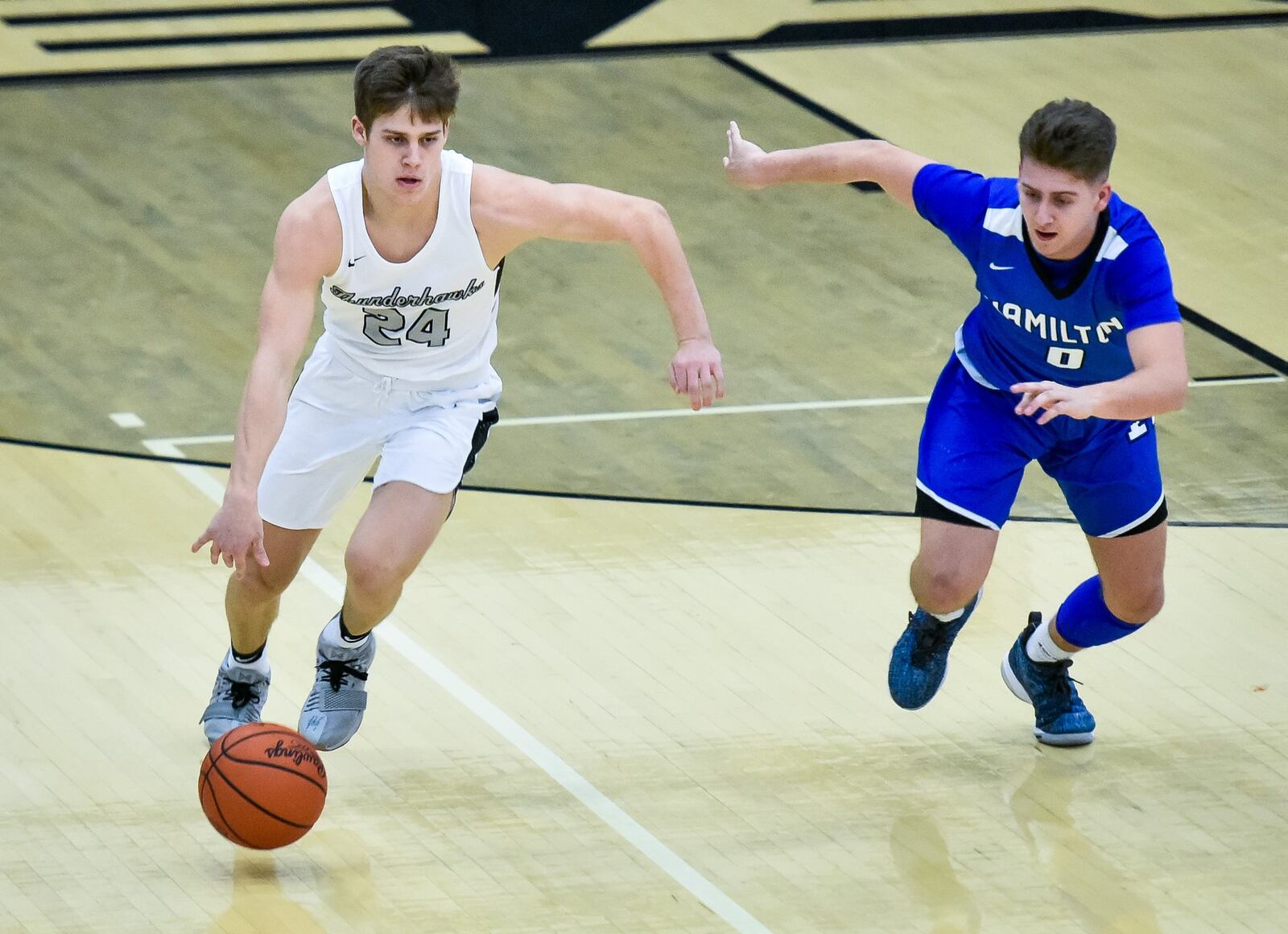 Lakota East’s Will Johnston dribbles the ball while being defended by Hamilton’s Payton Pennington during Friday night’s game in Libety Township. Hamilton won 65-62. NICK GRAHAM/STAFF