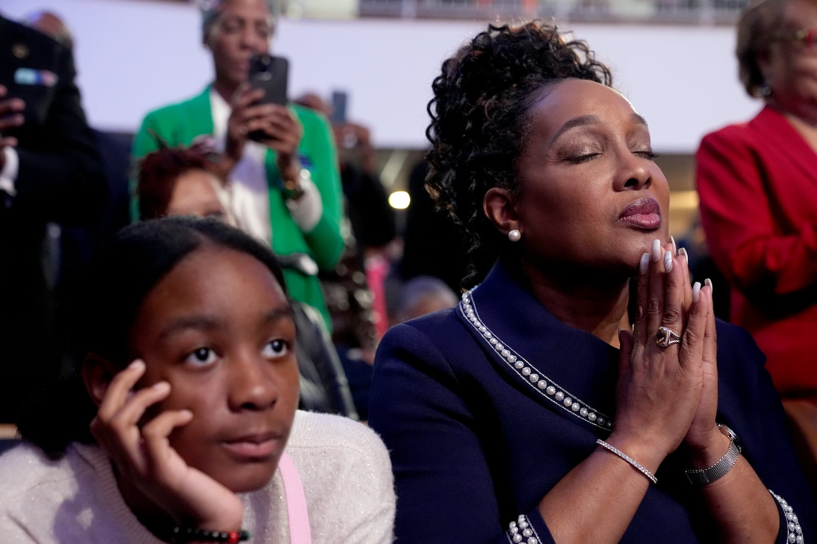 Attendees listen as Stevie Wonder performs "Redemption Song" during a church service and early vote event with Democratic presidential nominee Vice President Kamala Harris at Divine Faith Ministries International, Sunday, Oct. 20, 2024, in Jonesboro, Ga. (AP Photo/Jacquelyn Martin)