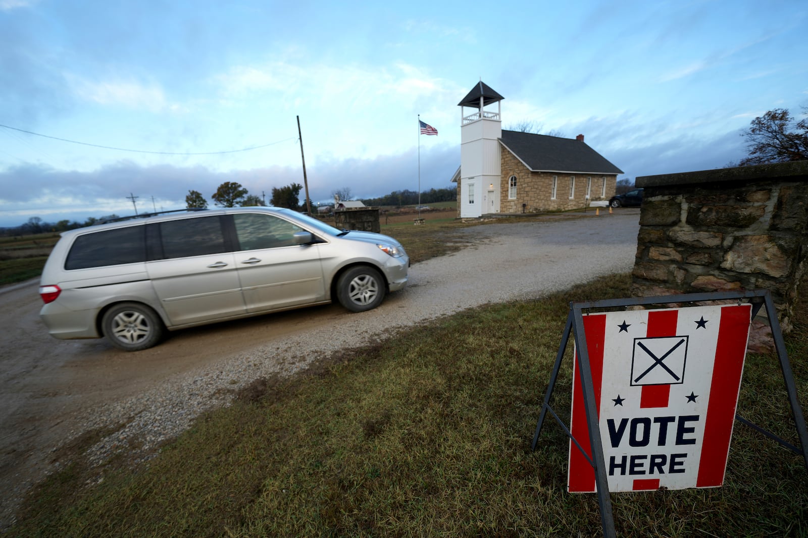 Voters arrive at the 146-year-old Buck Creek School to vote on Election Day, Tuesday, Nov. 5, 2024, in rural Perry, Kan. (AP Photo/Charlie Riedel)