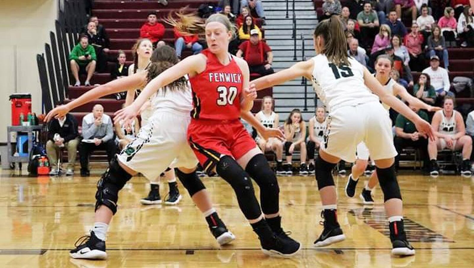 Fenwick’s Elena Daly (30) tries to make a move between Badin’s Shelby Nusbaum (left) and Grace Larkin (15) on a free-throw attempt during Tuesday night’s Division II sectional game at Lebanon. Fenwick won 53-46. CONTRIBUTED PHOTO BY TERRI ADAMS