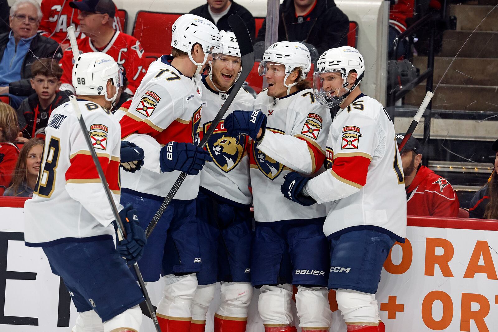 Florida Panthers' Jesper Boqvist, second right, celebrates his goal with Eetu Luostarinen (27), Evan Rodrigues (17), Nate Schmidt (88) and Anton Lundell (15) during the first period of an NHL hockey game against the Carolina Hurricanes in Raleigh, N.C., Friday, Nov. 29, 2024. (AP Photo/Karl B DeBlaker)