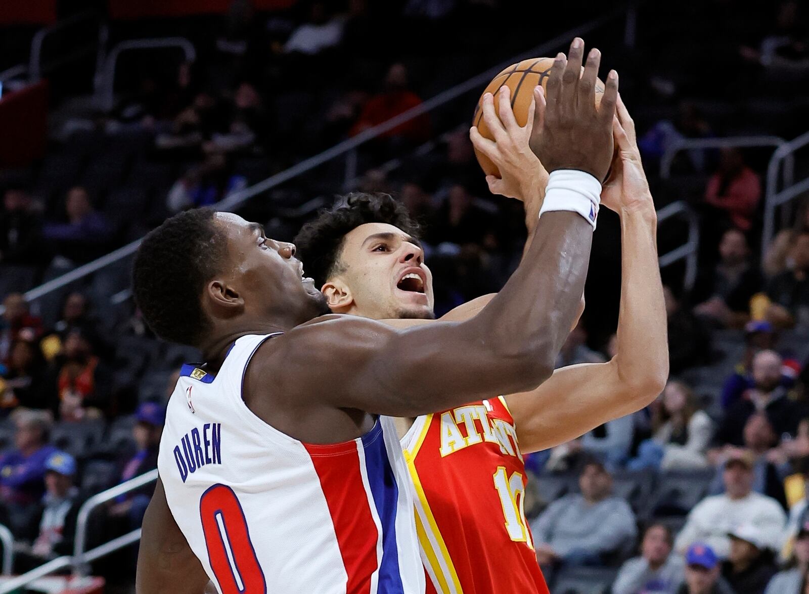 Atlanta Hawks forward Zaccharie Risacher, right, is defending by Detroit Pistons center Jalen Duren (0) while looking to shoot during the first half of an NBA basketball game Monday, Feb. 3, 2025, in Detroit. (AP Photo/Duane Burleson)