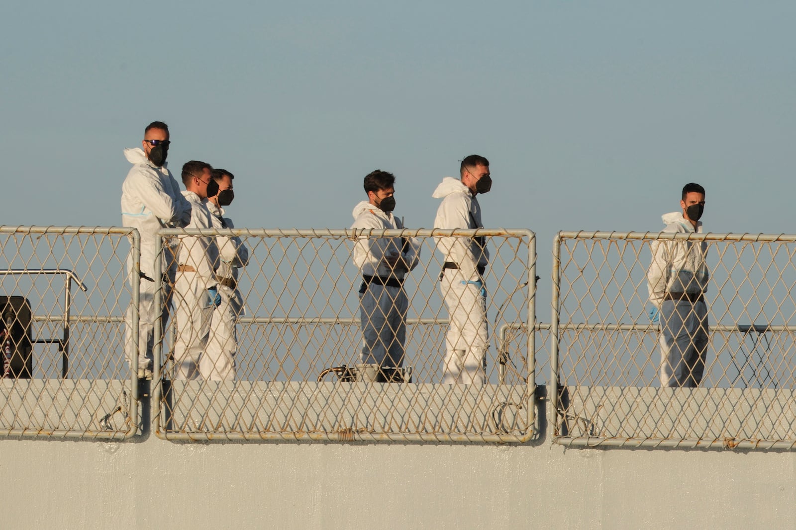 Security official stand on the Italian navy ship Libra as it arrives at the port of Shengjin, northwestern Albania Wednesday, Oct. 16, 2024, carrying the first group of migrants who were intercepted in international waters. (AP Photo/Vlasov Sulaj)