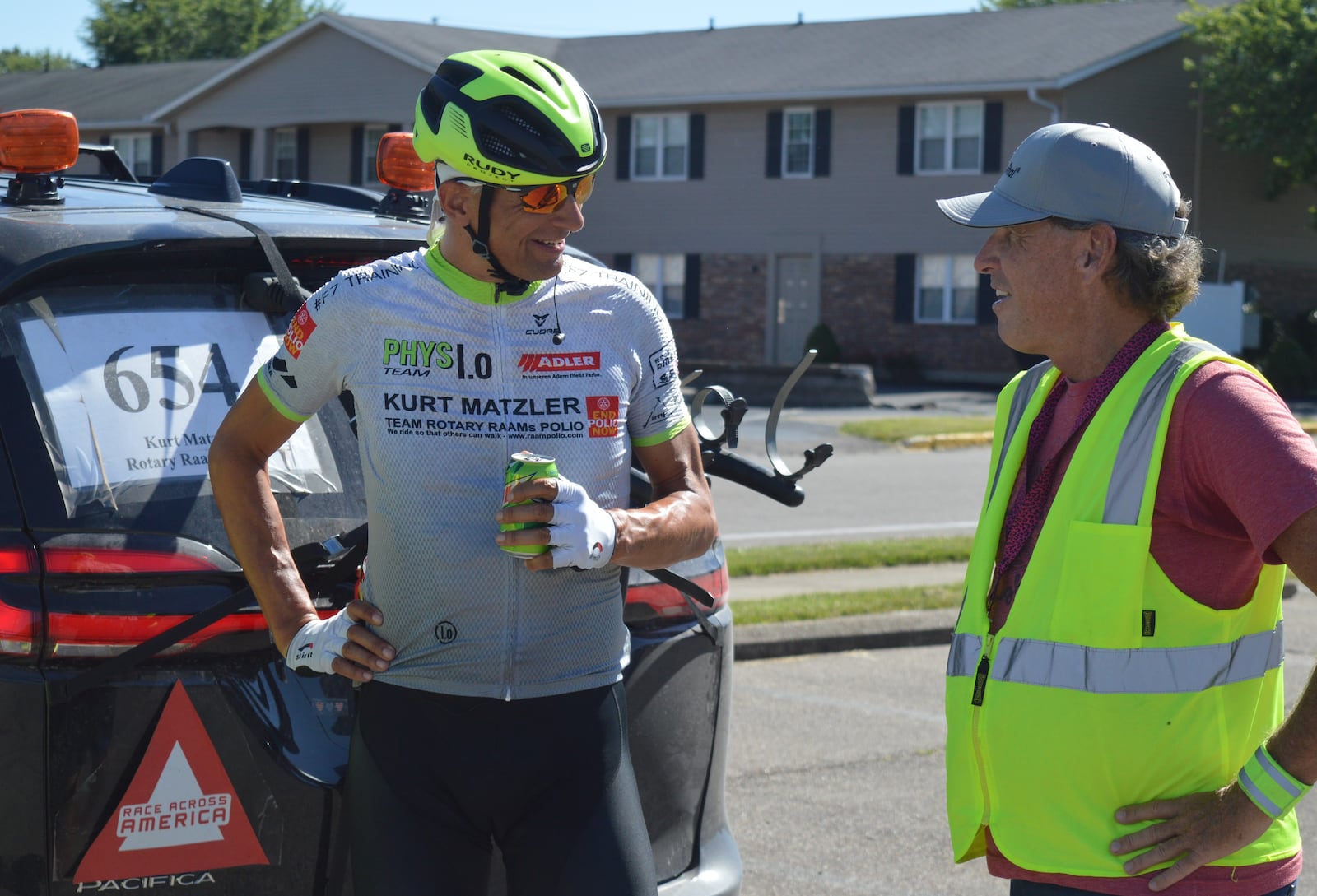 Austrian Kurt Matzler (left) not only enjoyed a cold drink and talked over strategy with support team members but he ducked into one of their vans and took a short power nap before heading back out on the course of the Race Across America June 23. BOB RATTERMAN/CONTRIBUTED