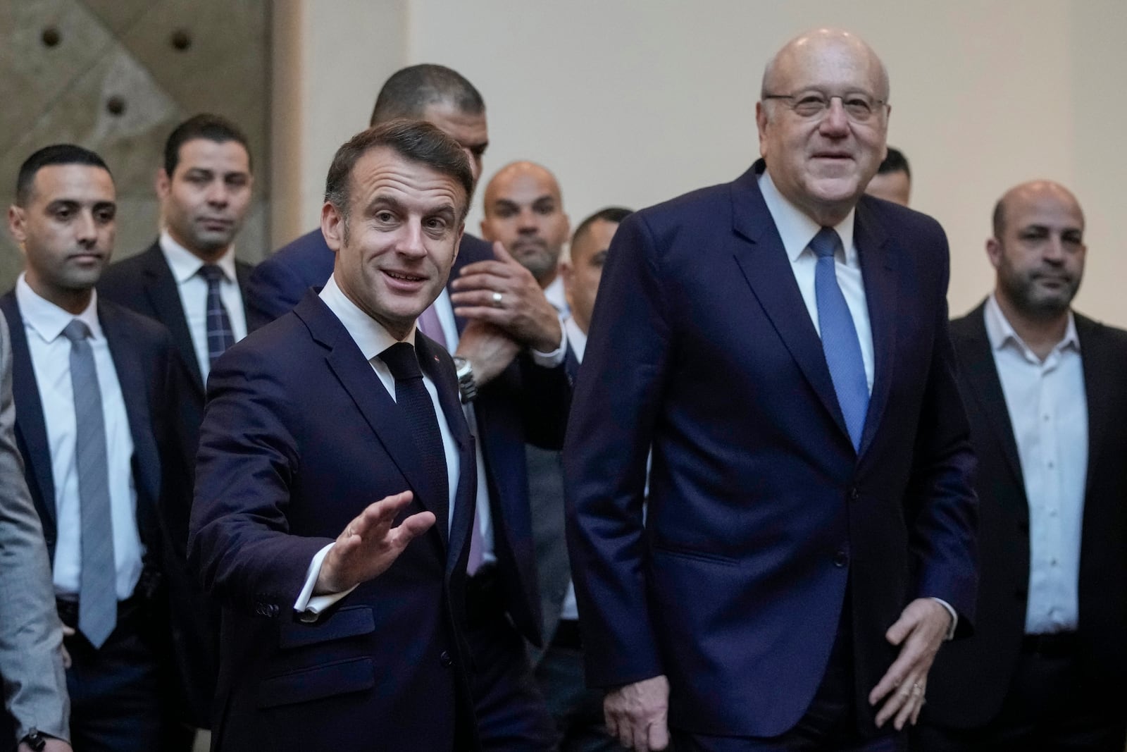 French President Emmanuel Macron gestures after his meeting with Lebanese caretaker Prime Minister Najib Mikati, right, upon his arrival at Beirut's Rafic Hariri International Airport in Beirut, Lebanon, Friday, Jan. 17, 2025. (AP Photo/Hassan Ammar)