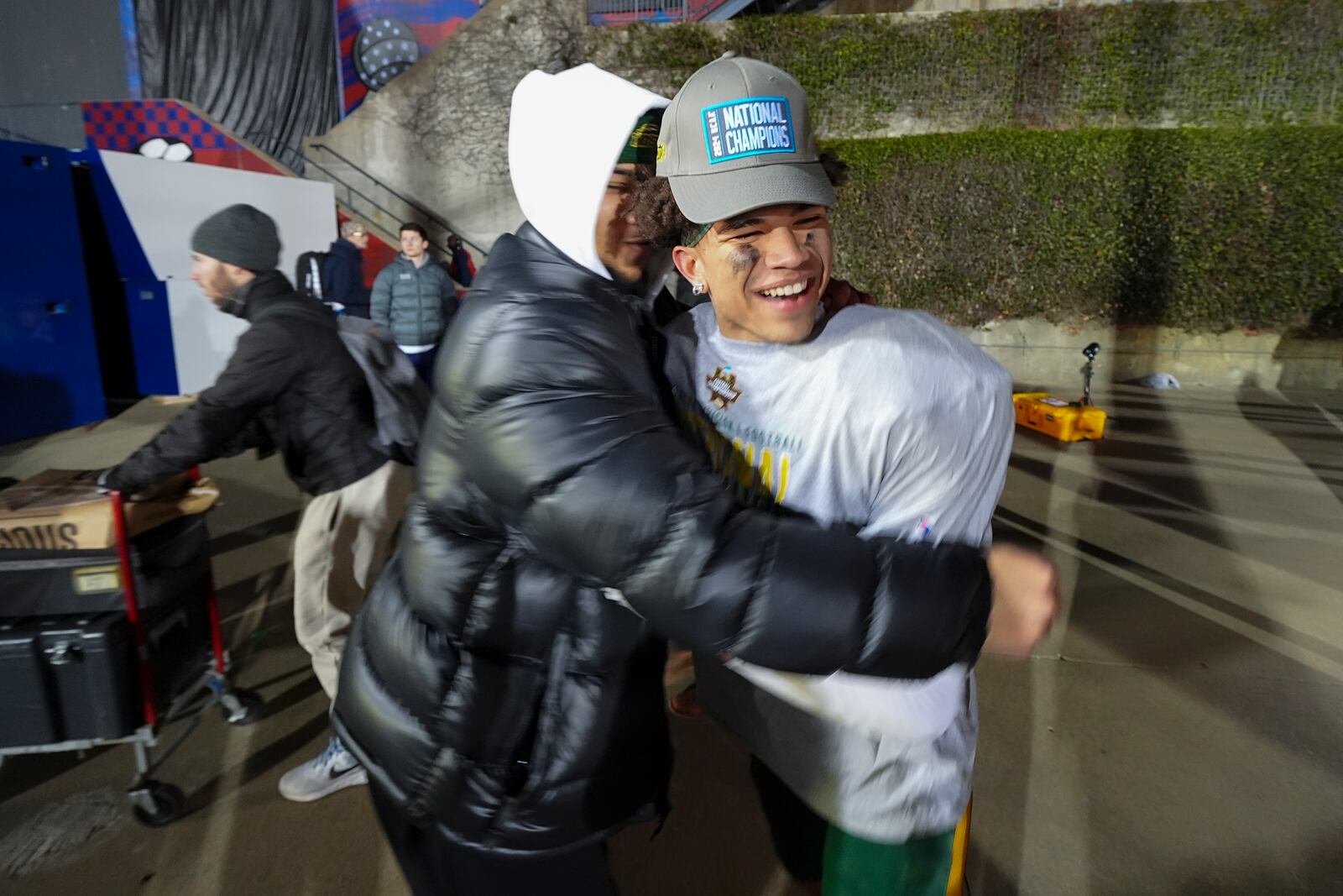 North Dakota State wide receiver Bryce Lance, right, is hugged by his brother, Dallas Cowboys NFL football quarterback Trey Lance, following the FCS Championship NCAA college football game against Montana State, Monday, Jan. 6, 2025, in Frisco, Texas. North Dakota State won 35-32. (AP Photo/Julio Cortez)