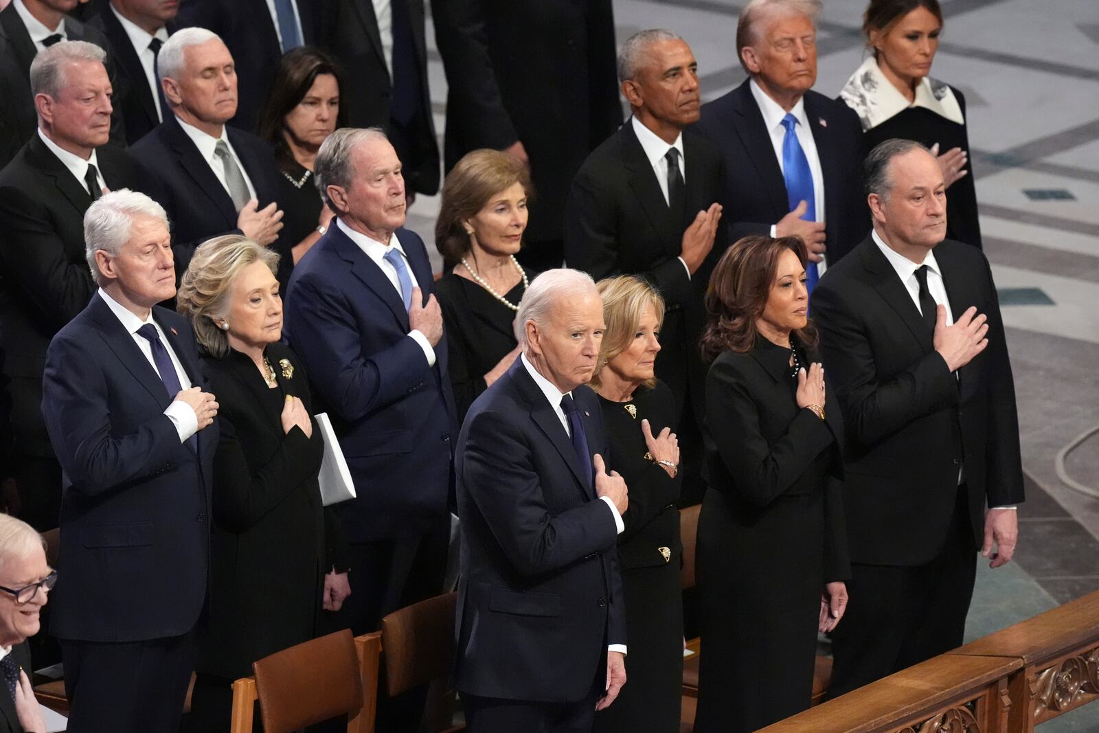 Front row, from left, President Joe Biden, first lady Jill Biden, Vice President Kamala Harris and second gentleman Doug Emhoff and second row from left, former President Bill Clinton, former Secretary of State Hillary Clinton, former President George W. Bush, Laura Bush, former President Barack Obama, President-elect Donald Trump and Melania Trump, stand during the state funeral for former President Jimmy Carter at Washington National Cathedral in Washington, Thursday, Jan. 9, 2025. (AP Photo/Jacquelyn Martin)