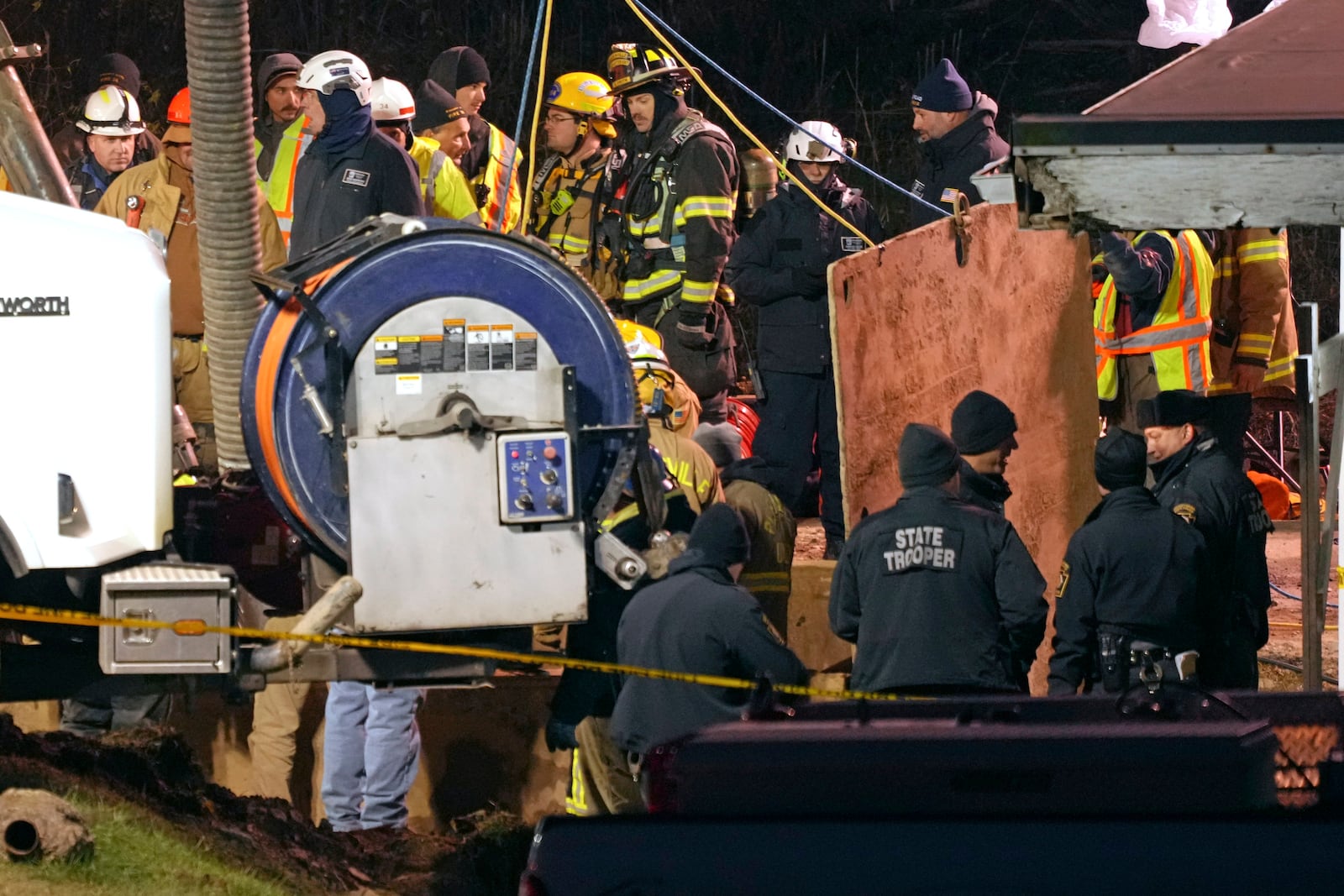 Rescue workers search in a sinkhole for Elizabeth Pollard, who disappeared while looking for her cat, in Marguerite, Pa., Tuesday, Dec. 3, 2024. (AP Photo/Gene J. Puskar)