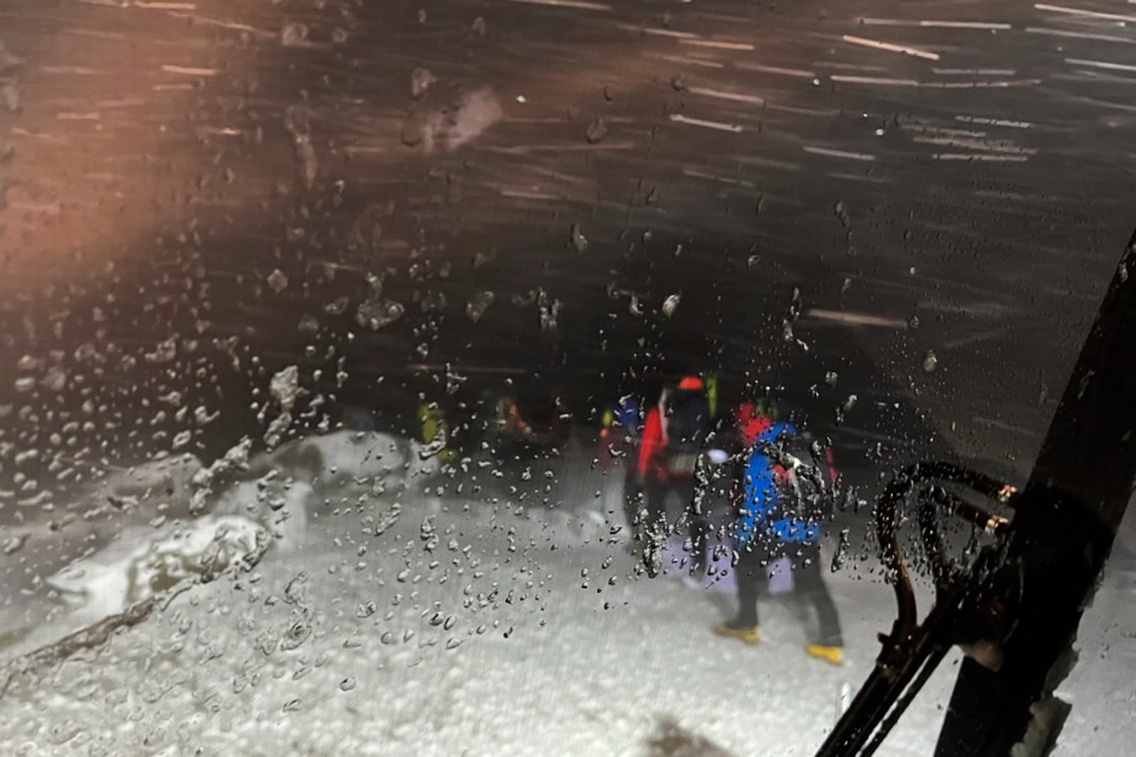 This image provided by the New Hampshire Fish and Game Department shows rescue hikers leaving on foot from the summit, on Mount Washington, N.H., Sunday, Feb. 2, 2025. (New Hampshire Fish and Game Department photo via AP)