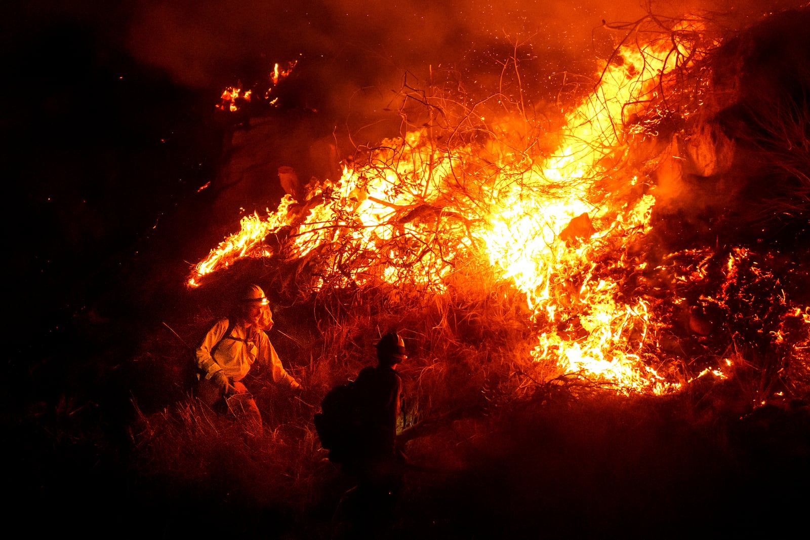 Firefighters battle the Lilac Fire along Interstate 15 near the Bonsall community of San Diego County, Calif., on Tuesday, Jan. 21, 2025. (AP Photo/Noah Berger)