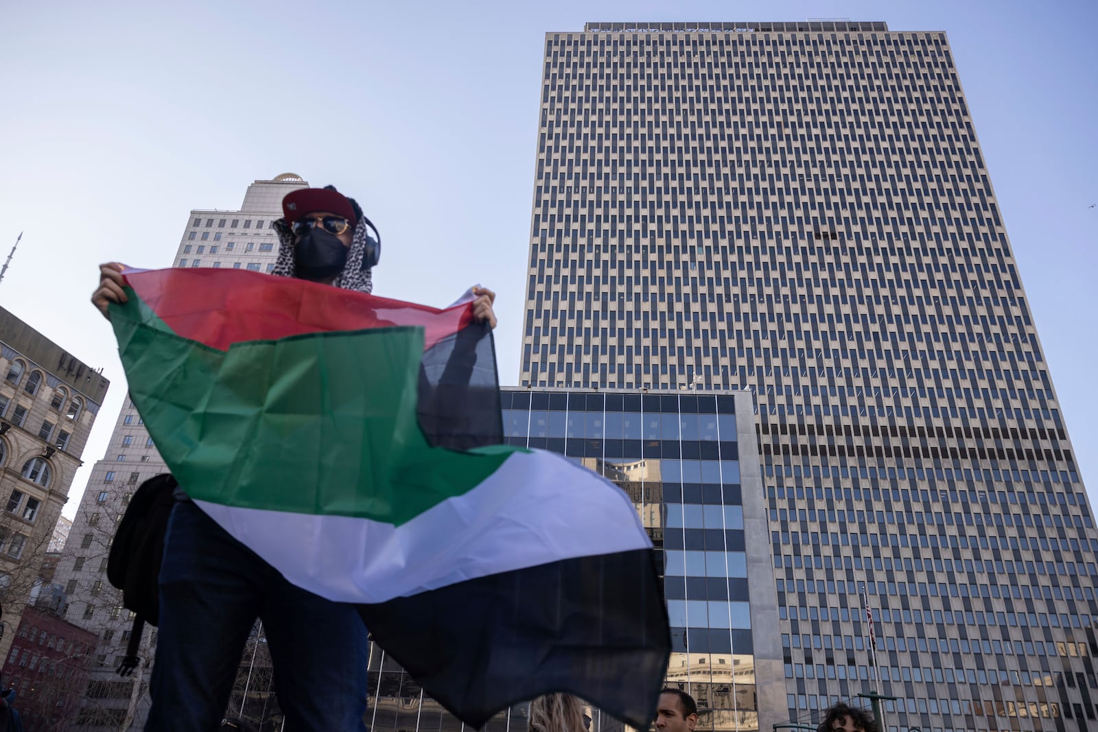 A protester holds Palestinian flag in front of Federal Plaza during a demonstration in support of Palestinian activist Mahmoud Khalil, Monday, March 10, 2025, in New York. (AP Photo/Yuki Iwamura)