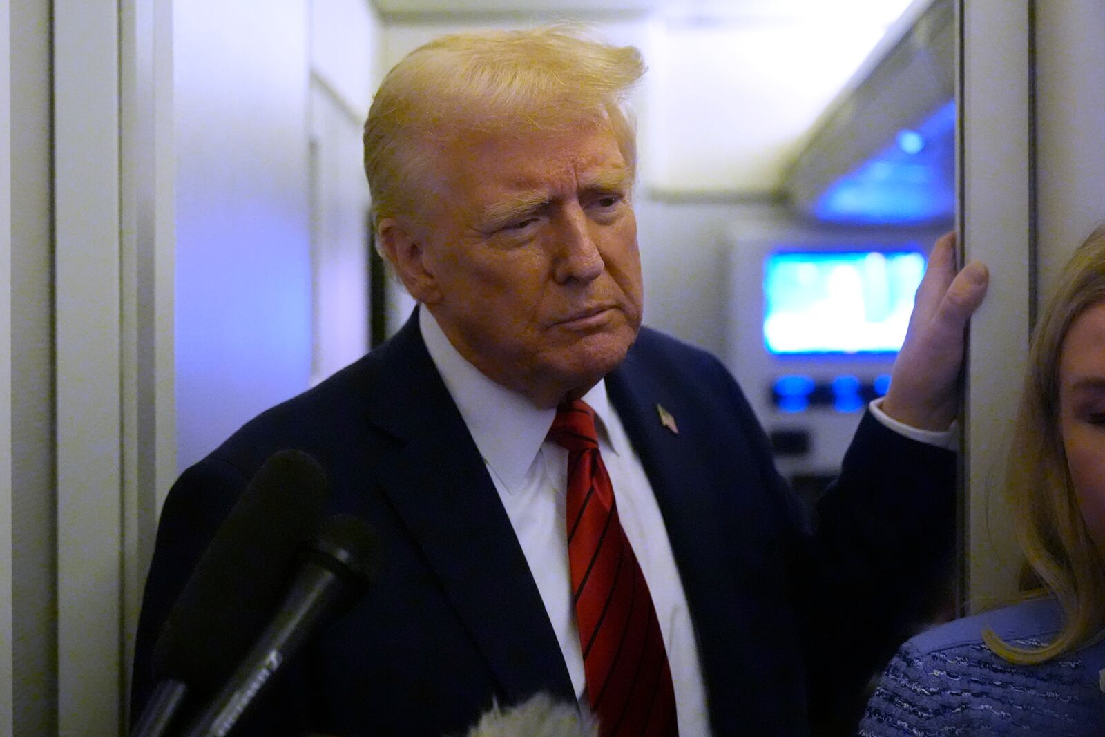 President Donald Trump speaks to reporters aboard Air Force One en route from Miami to Joint Base Andrews, Md., Monday, Jan. 27, 2025. (AP Photo/Mark Schiefelbein)