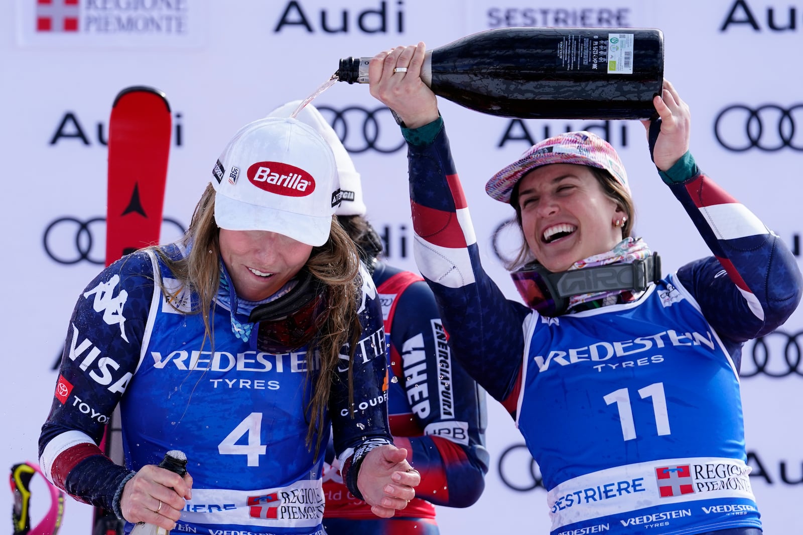 The winner United States' Mikaela Shiffrin and third placed United States' Paula Moltzan celebrate after an alpine ski, women's World Cup slalom, in Sestriere, Italy, Sunday, Feb. 23, 2025. (AP Photo/Piermarco Tacca)