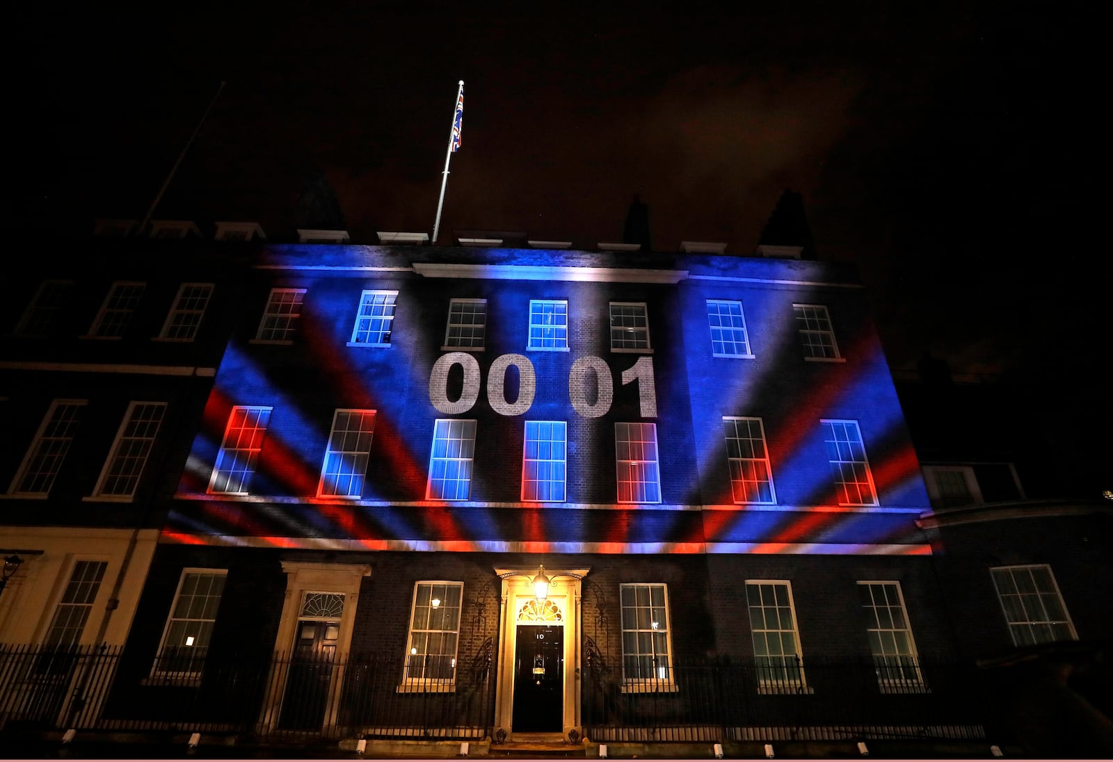 FILE - A countdown to Brexit timer and the colors of the British Union flag illuminate the exterior of 10 Downing street, the residence of the British Prime Minister, in London, England, Friday, Jan. 31, 2020. AP Photo/Kirsty Wigglesworth, File)