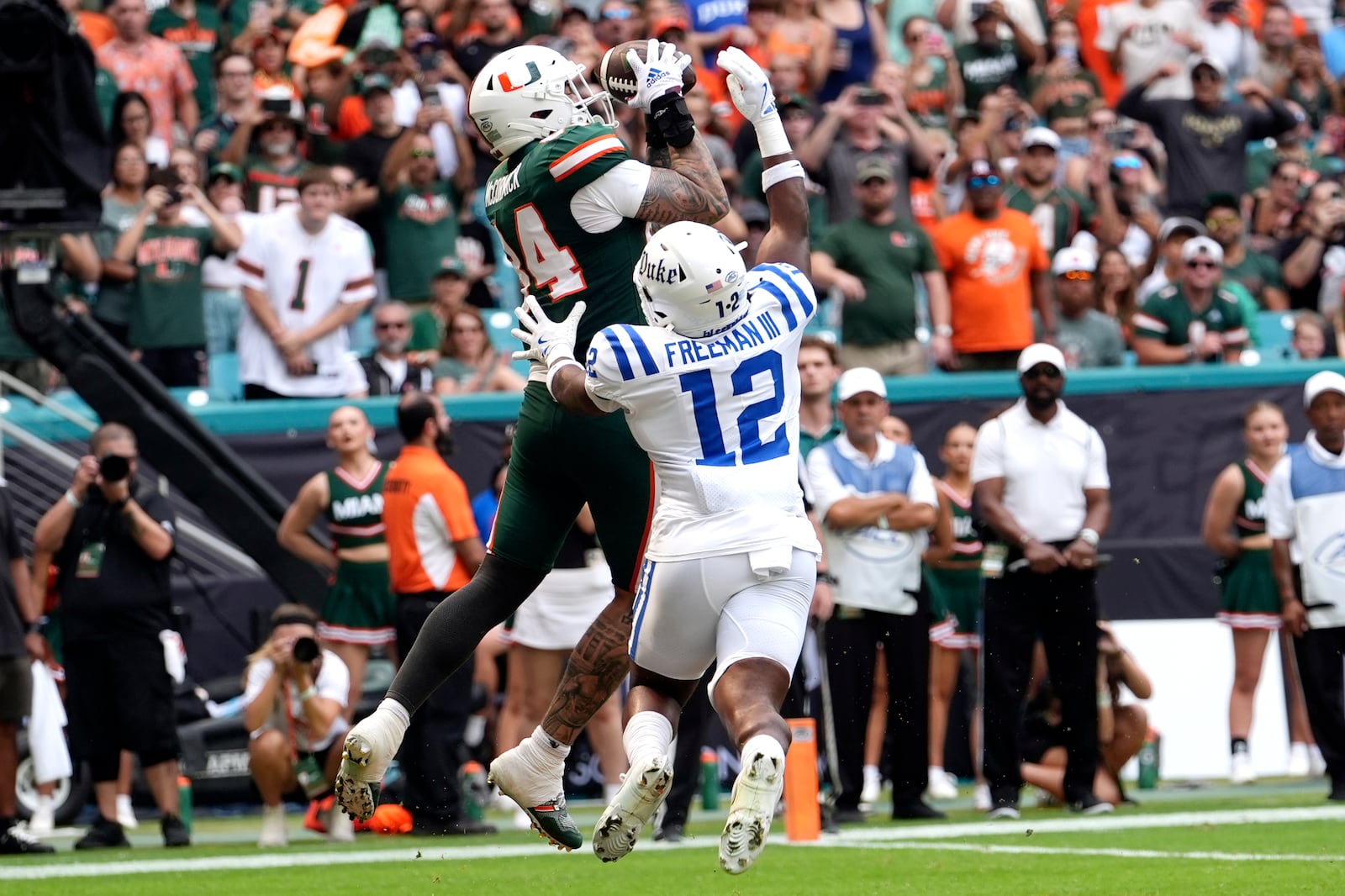 Miami tight end Cam McCormick (84) makes a catch for a touchdown over Duke linebacker Tre Freeman (12) during the first half of an NCAA college football game, Saturday, Nov. 2, 2024, in Miami Gardens, Fla. (AP Photo/Lynne Sladky)