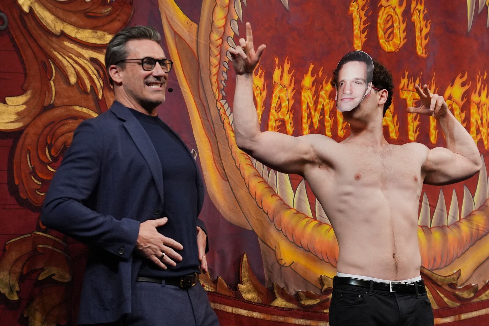 Harvard University's Hasty Pudding Theatricals Man of the Year Jon Hamm, left, grabs his waist while an actor portraying Paul Rudd flexes Friday, Jan. 31, 2025, in Cambridge, Mass. (AP Photo/Charles Krupa)