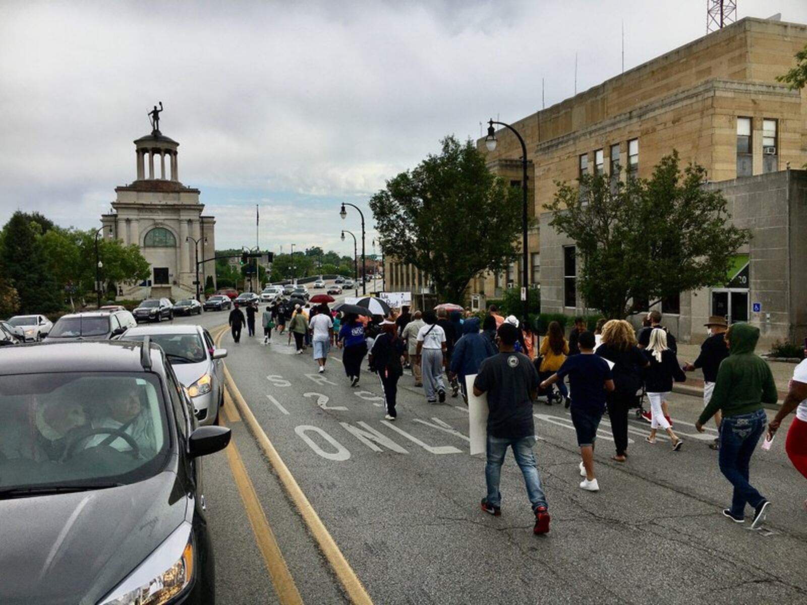 More than 150 demonstrators marched peacefully through downtown Hamilton and across the High Street bridge into the west Hamilton business district Saturday, June 13. The march was the first large organized event by area black pastors of predominantly African-American churches to protest in the wake of the death of George Floyd while in police custody. The group circled back over the bridge and marched to the Butler county administration building where they listened to speeches calling for greater racial equality and justice. MICHAEL D. CLARK / STAFF