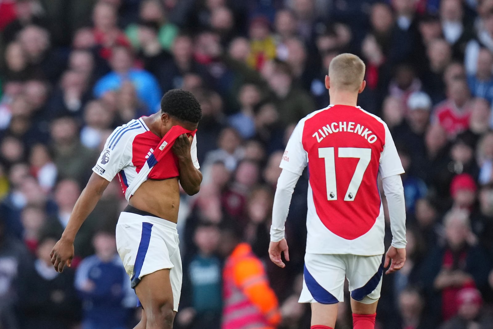 Arsenal's Myles Lewis-Skelly, left, reacts after receiving a red card during the English Premier League soccer match between Arsenal and West Ham United at Emirates stadium in London, Saturday, Feb. 22, 2025. (AP Photo/Kirsty Wigglesworth)