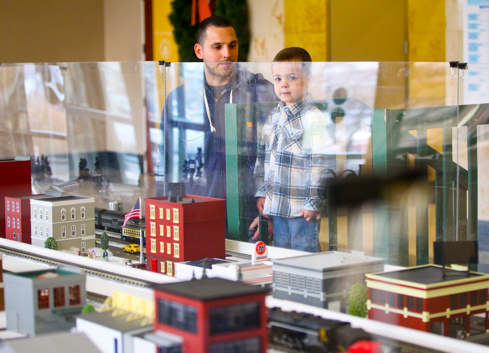 Hamilton’s holiday train exhibit allows viewers to press buttons to make them run.