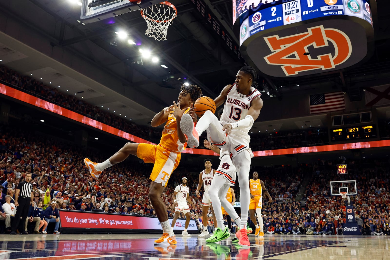 Auburn guard Miles Kelly (13) and Tennessee guard Chaz Lanier (2) battle for a rebound during the first half of an NCAA college basketball game, Saturday, Jan. 25, 2025, in Auburn. (AP Photo/Butch Dill)