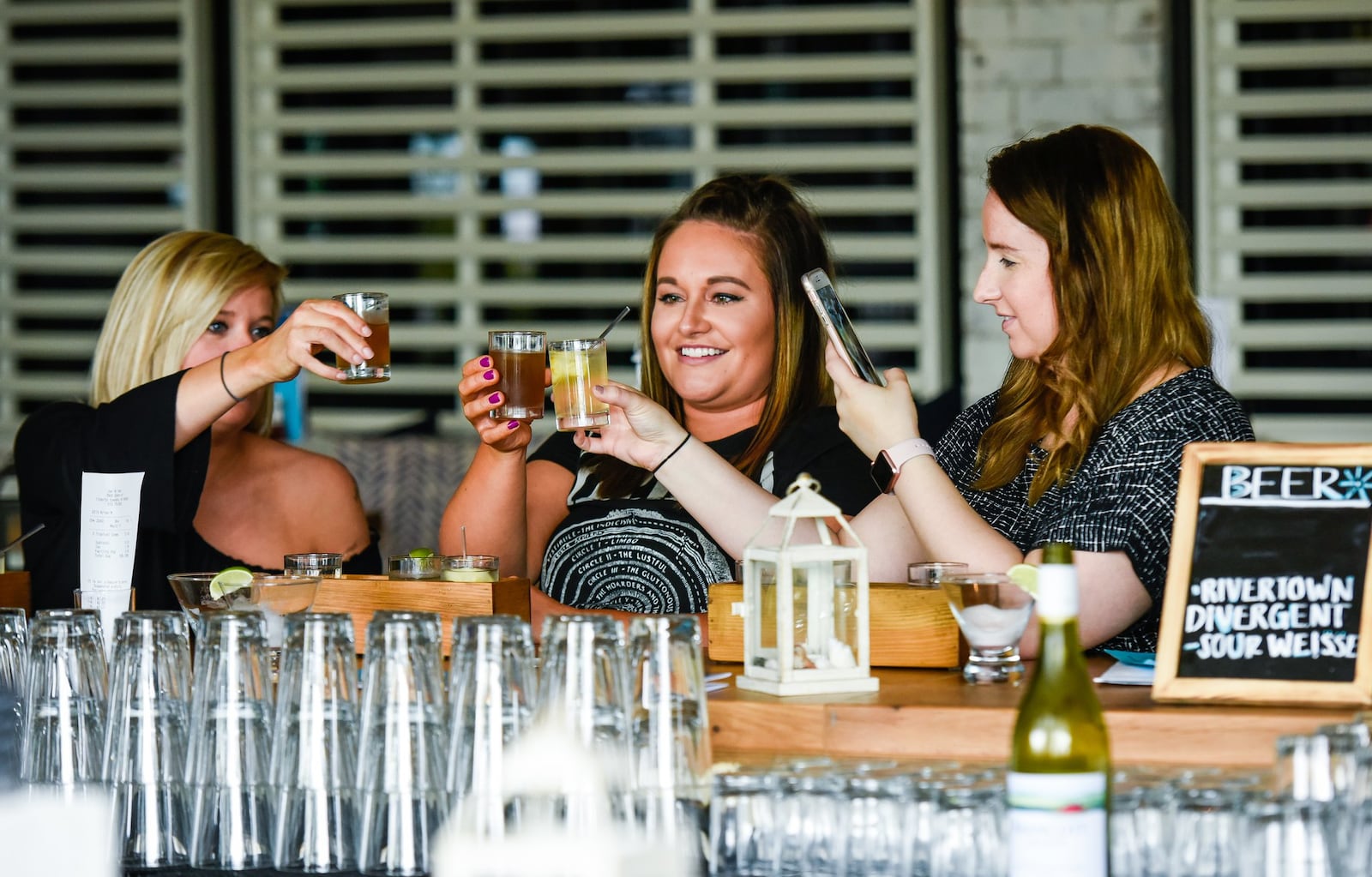 Aileena Morgan, left, Hannah Hess, middle, and Arrington Joyner sit at the bar at Bar Del Mar which is now open as a standalone bar and restaurant on the back side of the Brio at Liberty Center in Liberty Township. 