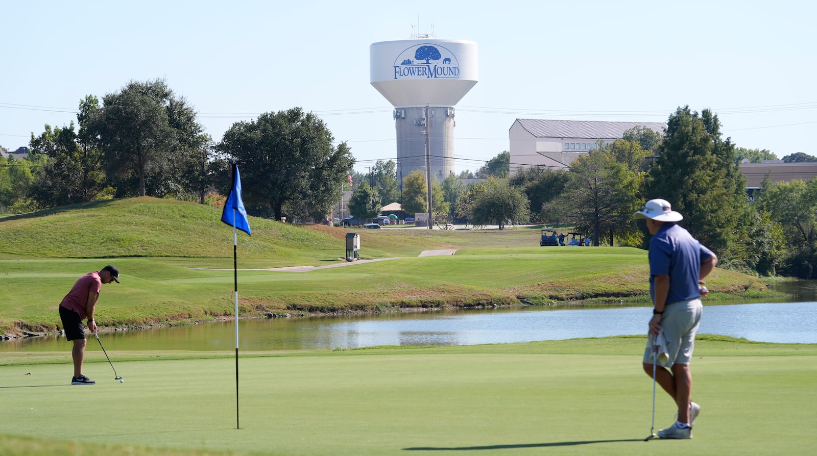 People play golf in Flower Mound, Texas, Friday, Oct. 4, 2024. (AP Photo/LM Otero)