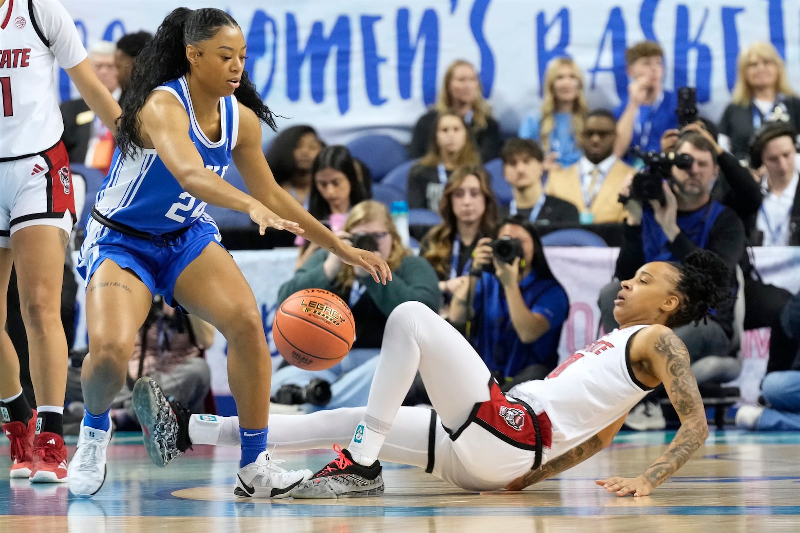 Duke guard Reigan Richardson (24) knocks down NC State guard Aziaha James (10) during an NCAA college basketball game in the championship of the Atlantic Coast Conference tournament Greensboro, N.C., Sunday, March 9, 2025. (AP Photo/Chuck Burton)