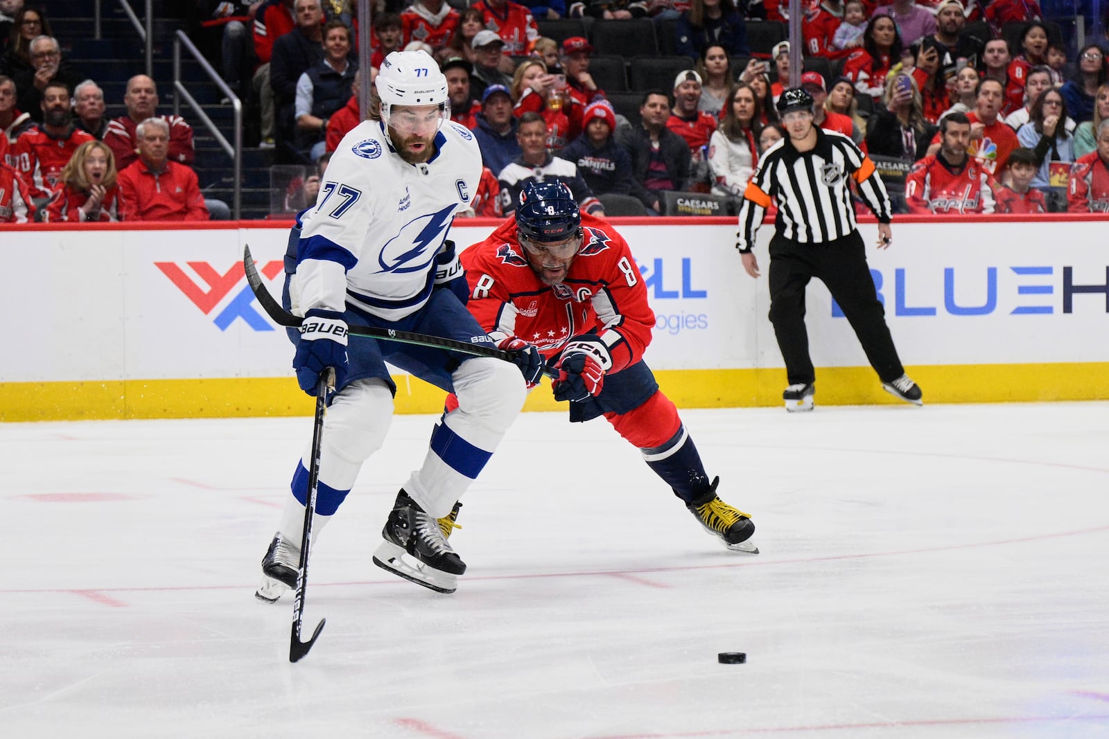 Washington Capitals left wing Alex Ovechkin (8) hooks Tampa Bay Lightning defenseman Victor Hedman (77) during the first period of an NHL hockey game, Saturday, March 1, 2025, in Washington. (AP Photo/Nick Wass)