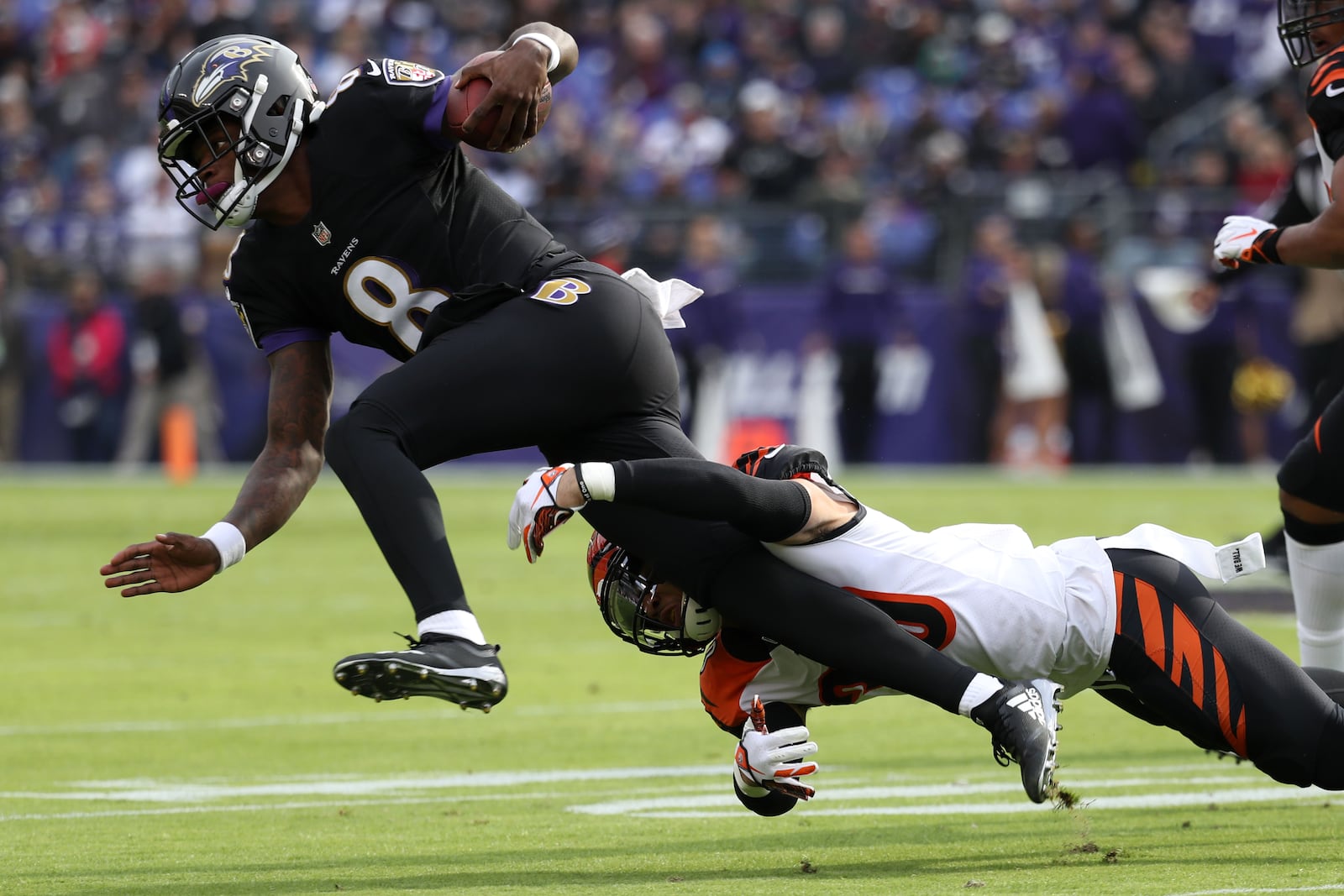 BALTIMORE, MD - NOVEMBER 18: Quarterback Lamar Jackson #8 of the Baltimore Ravens is tackled as he carries the ball by free safety Jessie Bates #30 of the Cincinnati Bengals in the first quarter at M&T Bank Stadium on November 18, 2018 in Baltimore, Maryland. (Photo by Rob Carr/Getty Images)